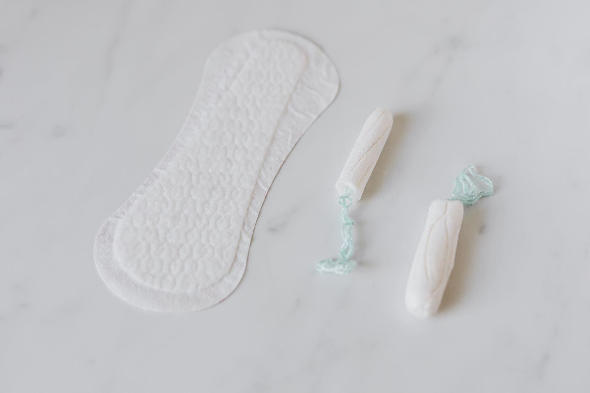 A close-up of three different types of Tucks pads: original medicated, witch hazel-only, and aloe-infused