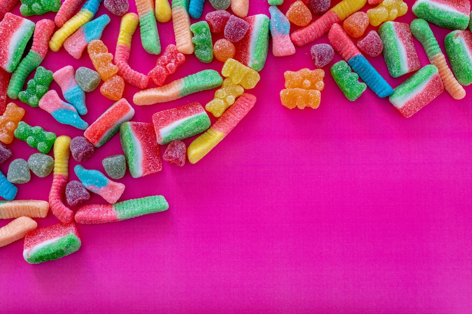colorful assortment of sour candies including Warheads, Sour Patch Kids, and Skittles