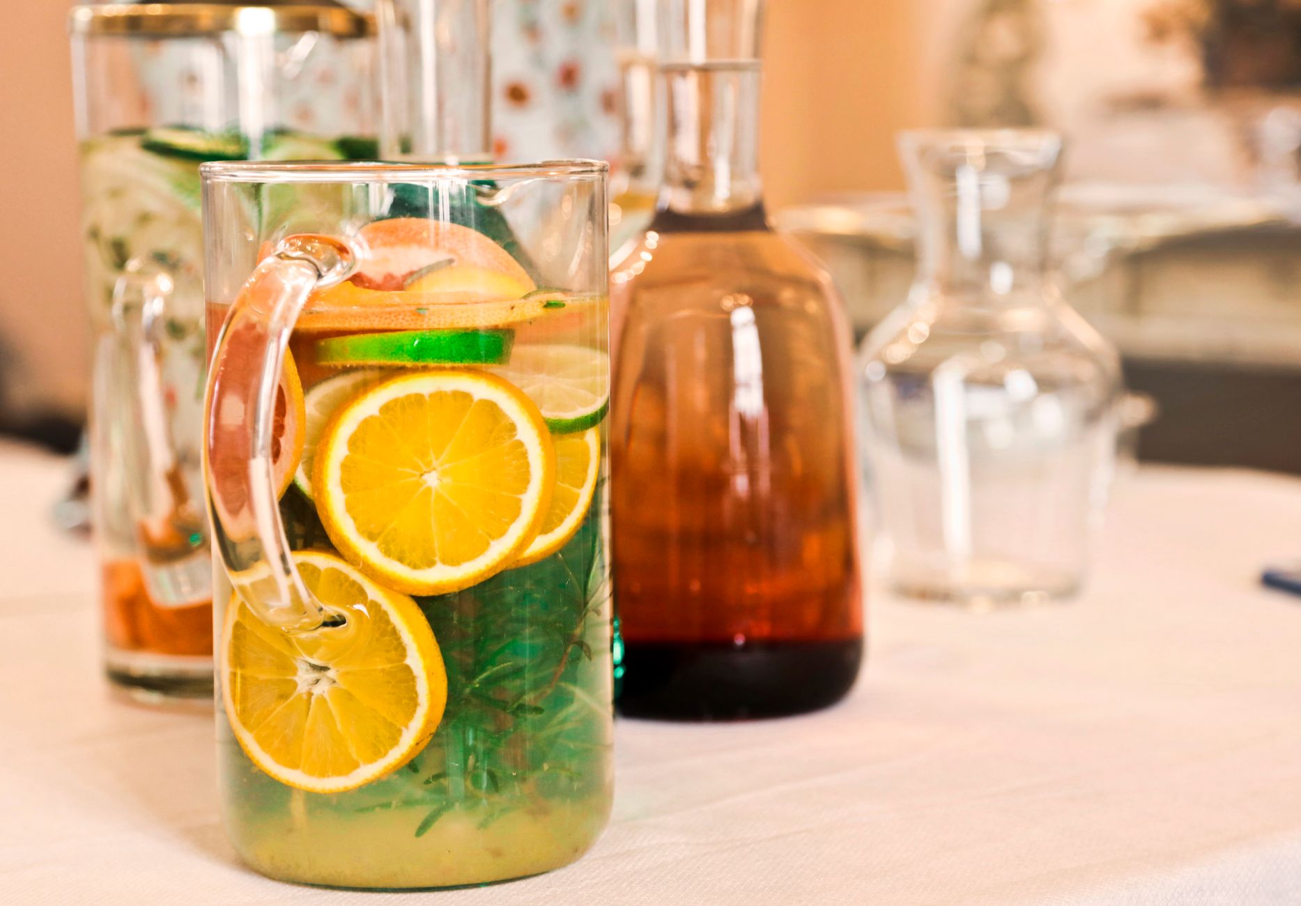 A selection of pregnancy‑safe sparkling beverages on a kitchen counter, showing La Croix, Bubly, and infused water bottles