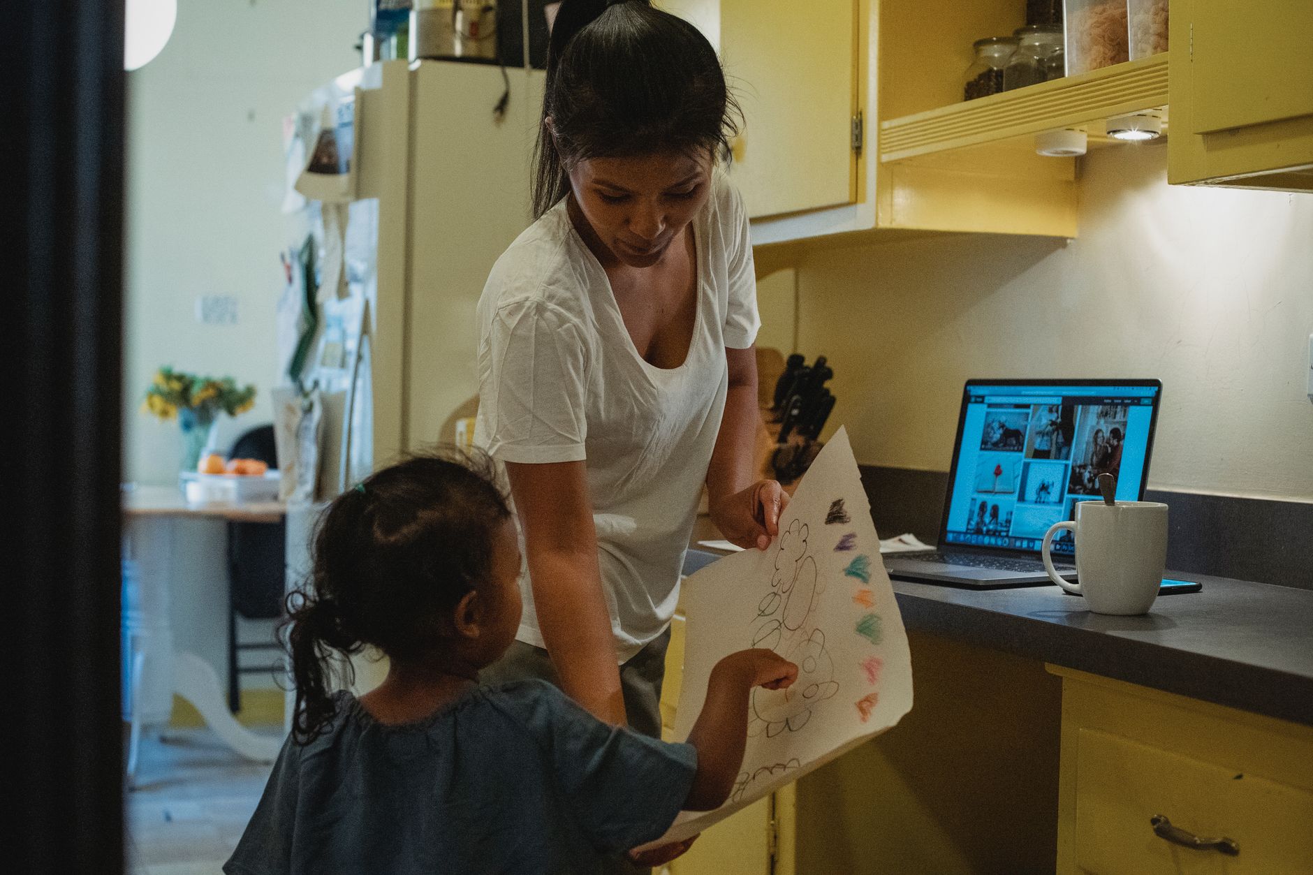 Parent reviewing influencer contract with child nearby