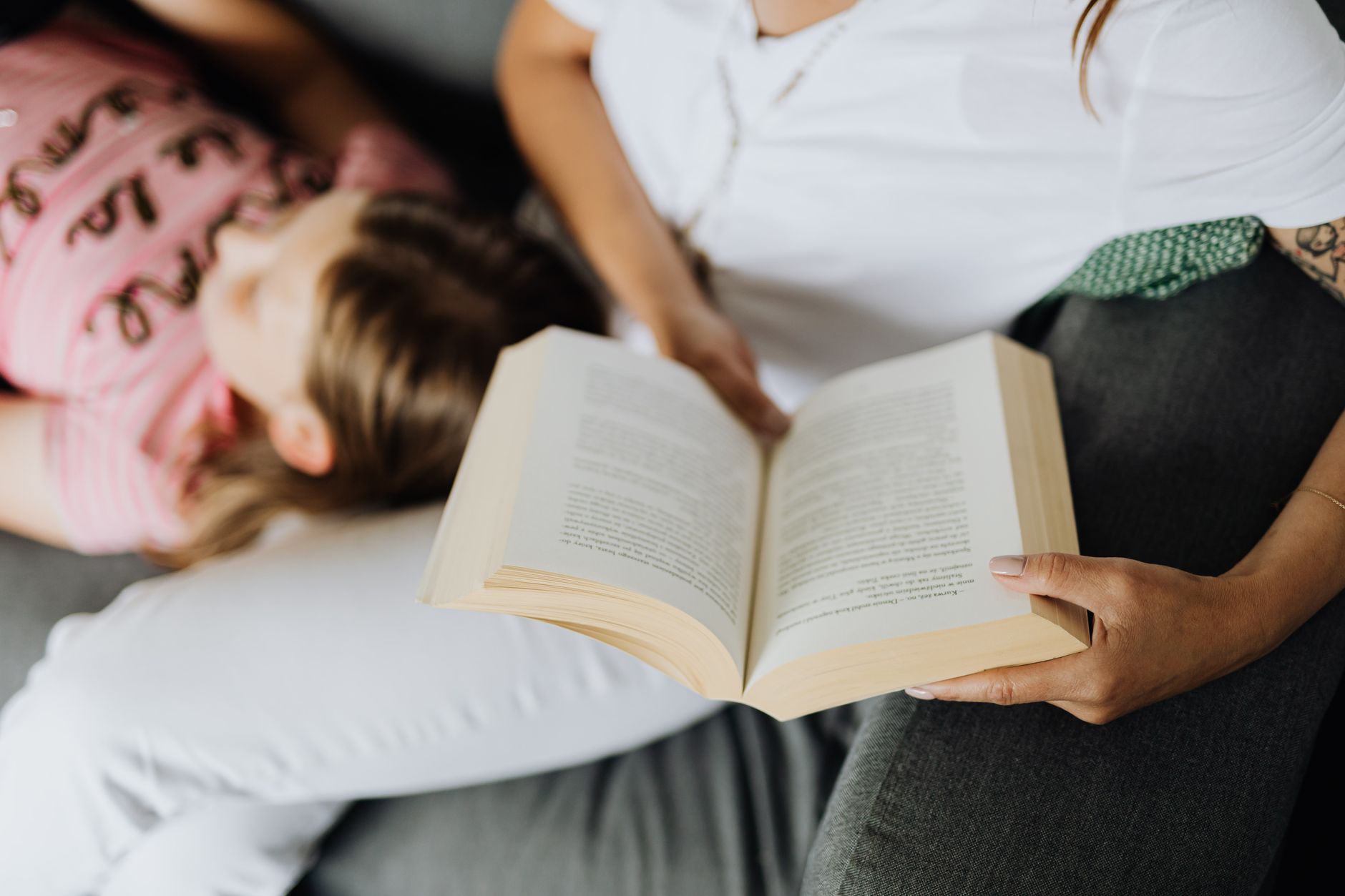 Mother reading to her child, creating a family narrative.