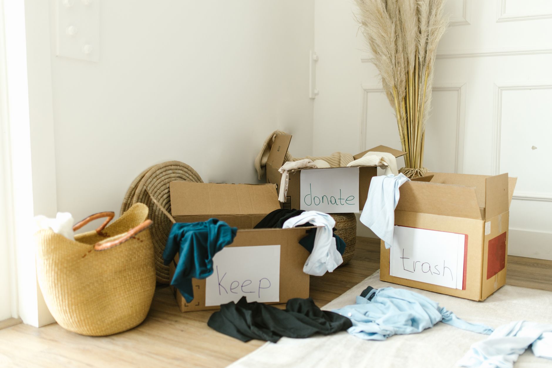A family standing around a table with labeled bins of sorted items, smiling
