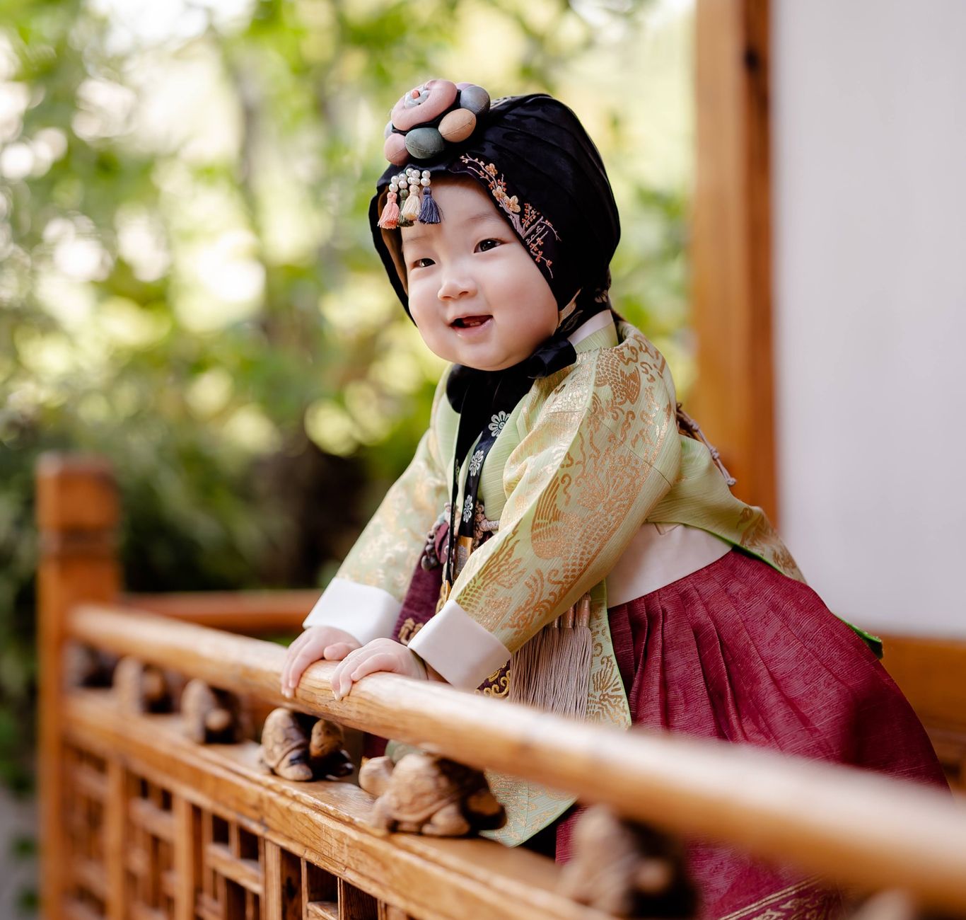 A baby dressed in a traditional Latinx outfit for their first birthday celebration