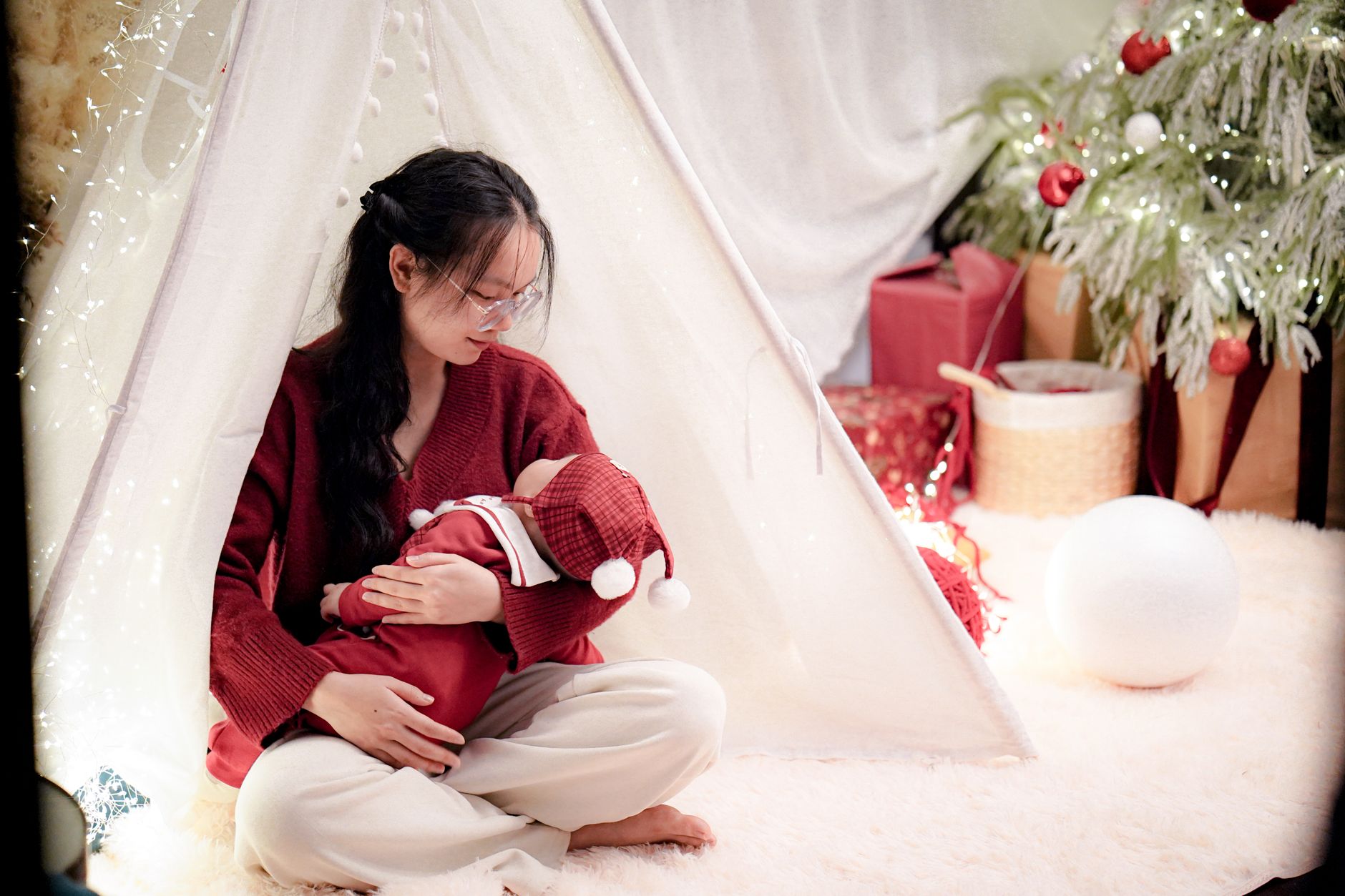 A modern Latinx mother journaling while her baby plays nearby, blending tradition with contemporary self-care