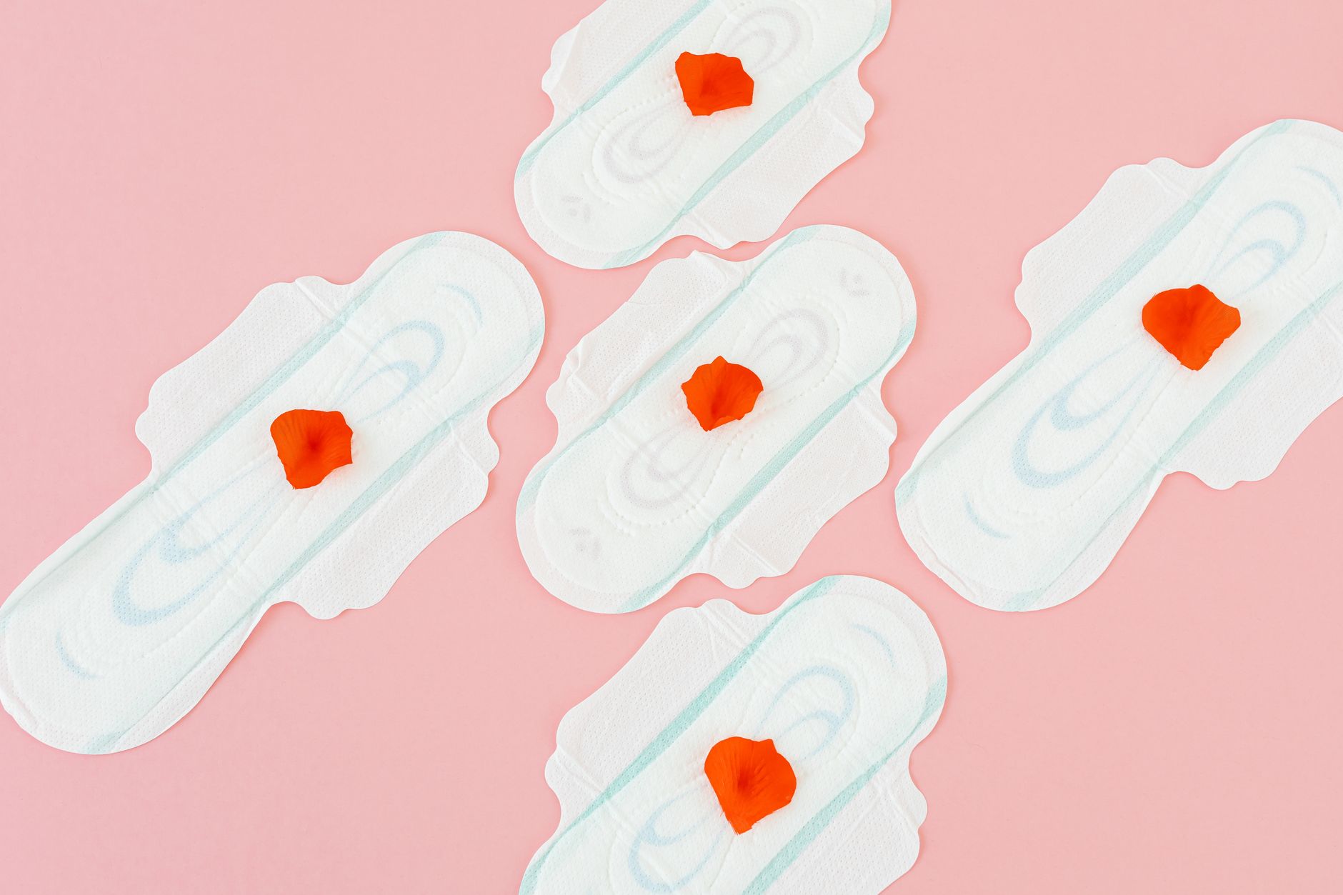 A soft, pastel illustration of the menstrual cycle showing ovulation, implantation, and the timing of possible spotting after intercourse