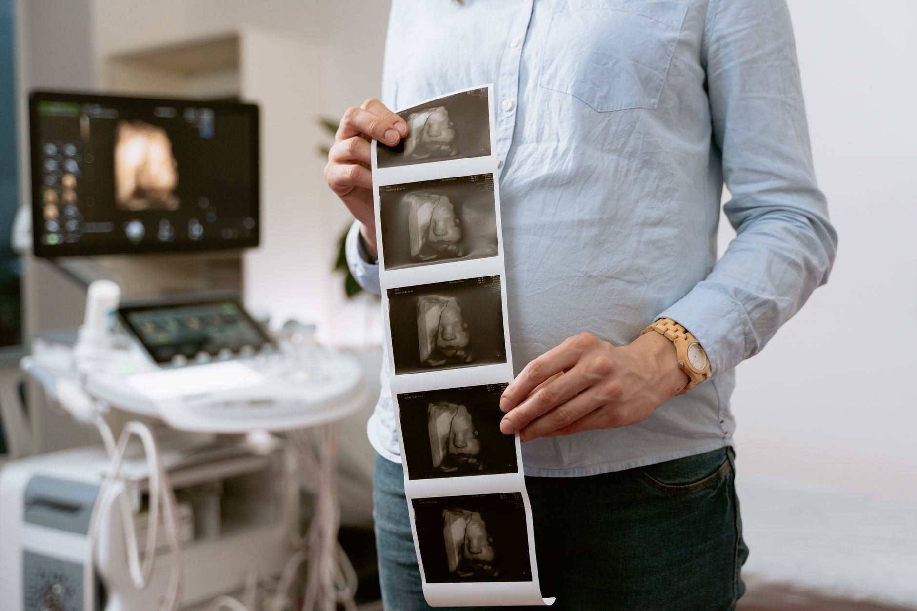 A small, stylized diagram showing a pregnant belly with a gentle, protective glow, surrounded by blurred medical symbols indicating care and caution.