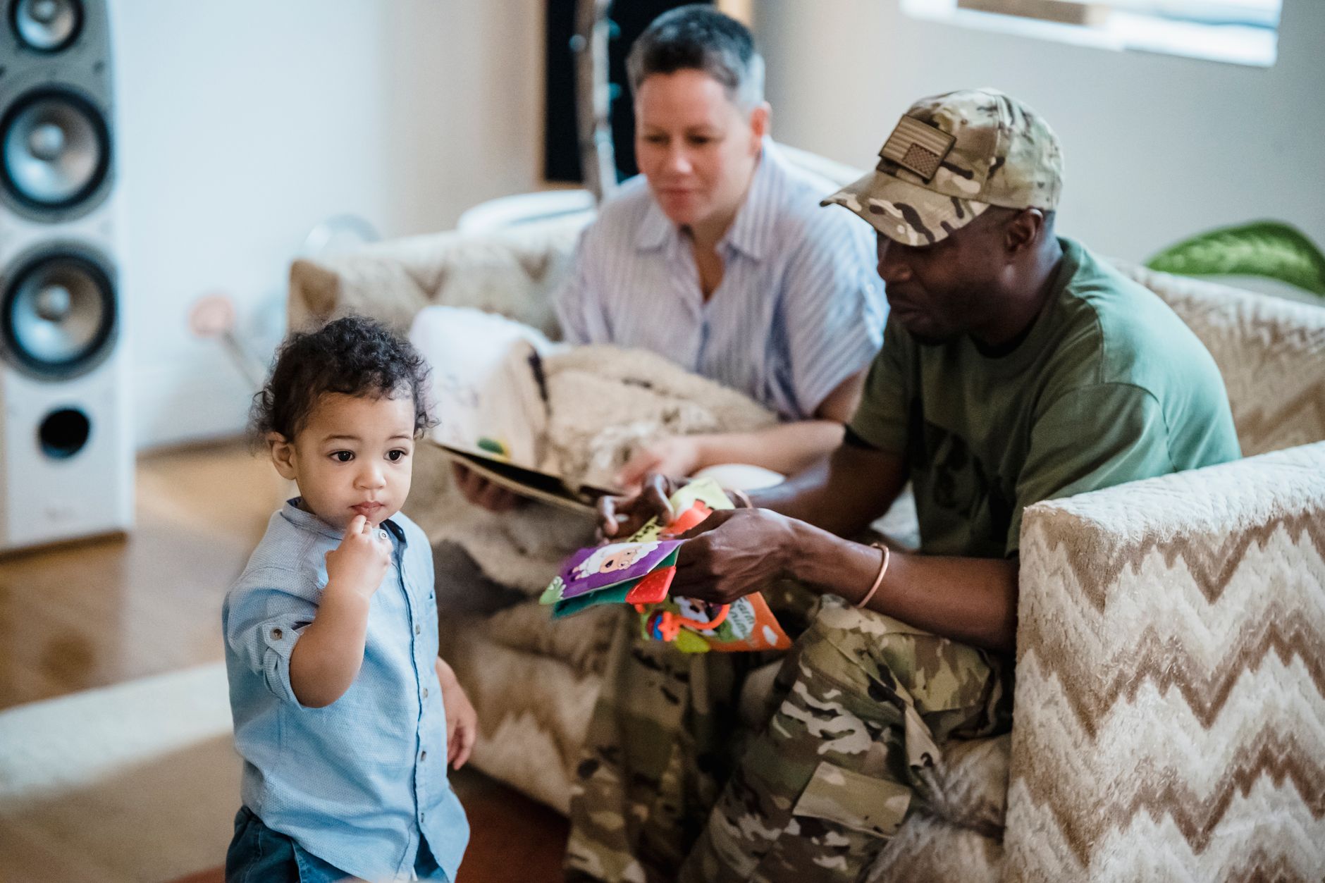 A military spouse mother sitting with her children, looking thoughtful and relaxed.