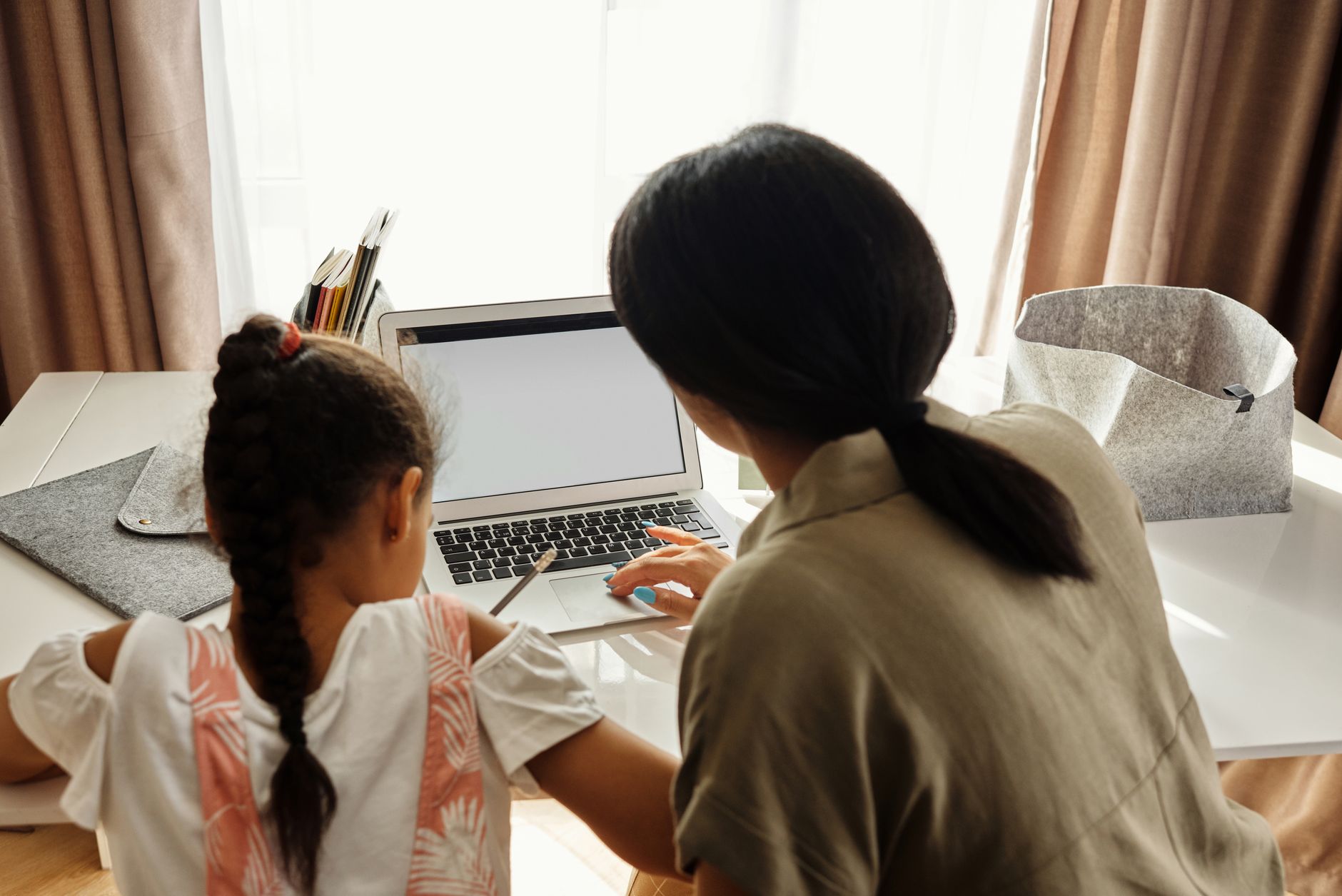 A military spouse mother working on educational benefits for her child at home.