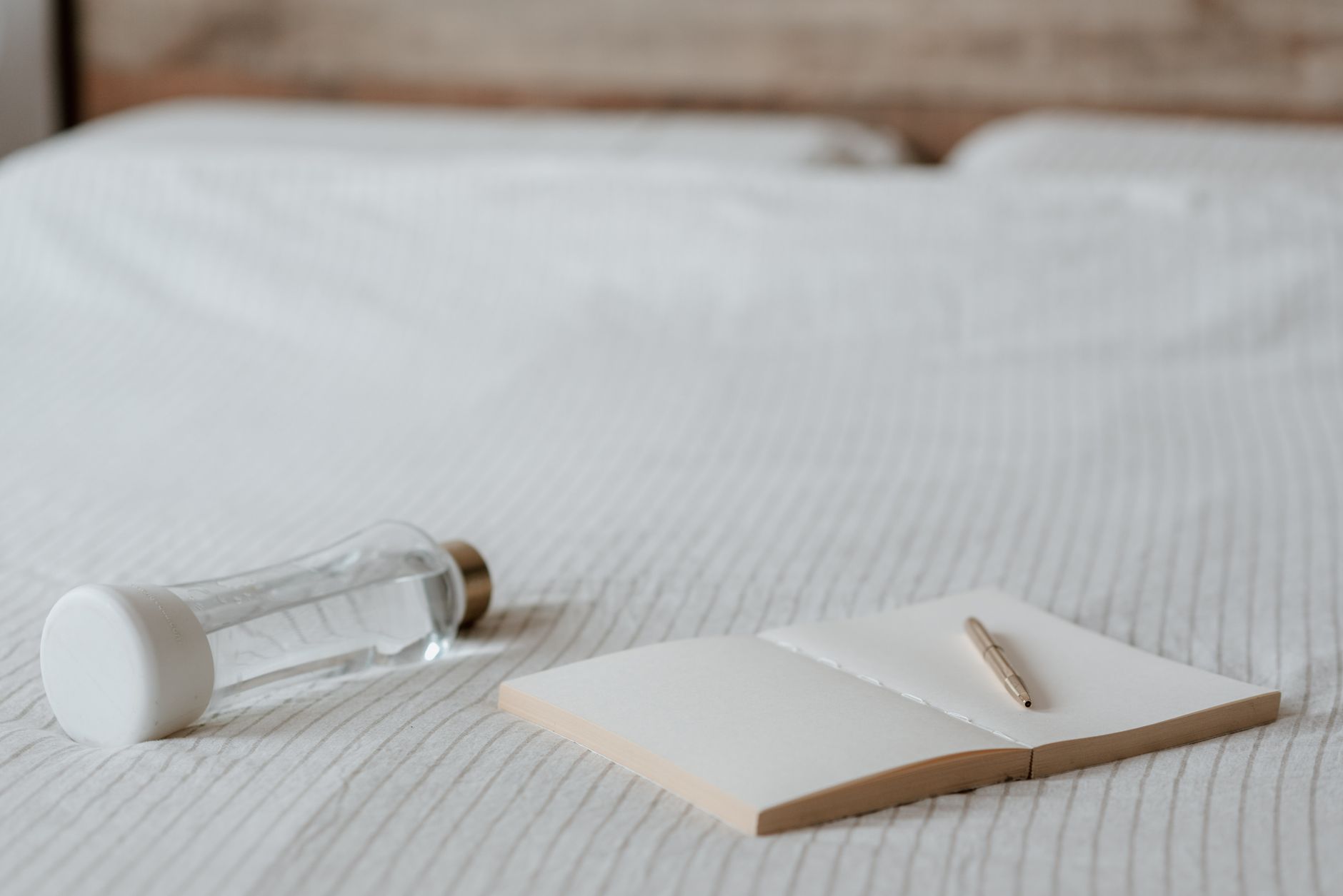 A calm bedroom scene with a glass of water, a notebook, and a soft blanket, illustrating a restful recovery after molar pregnancy treatment