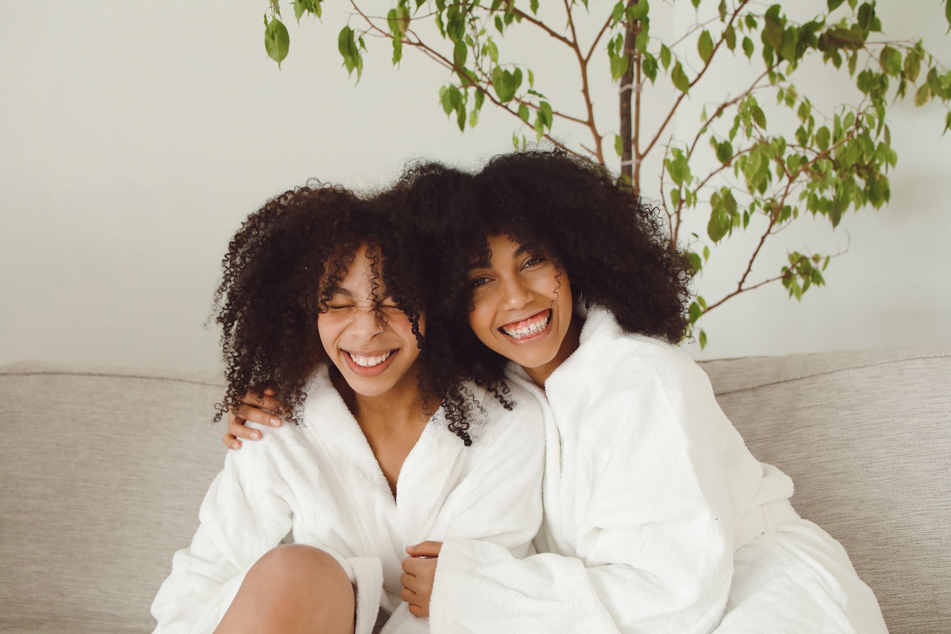 A twin pregnancy survival kit: a supportive pillow, a journal, snacks, and a cozy robe.