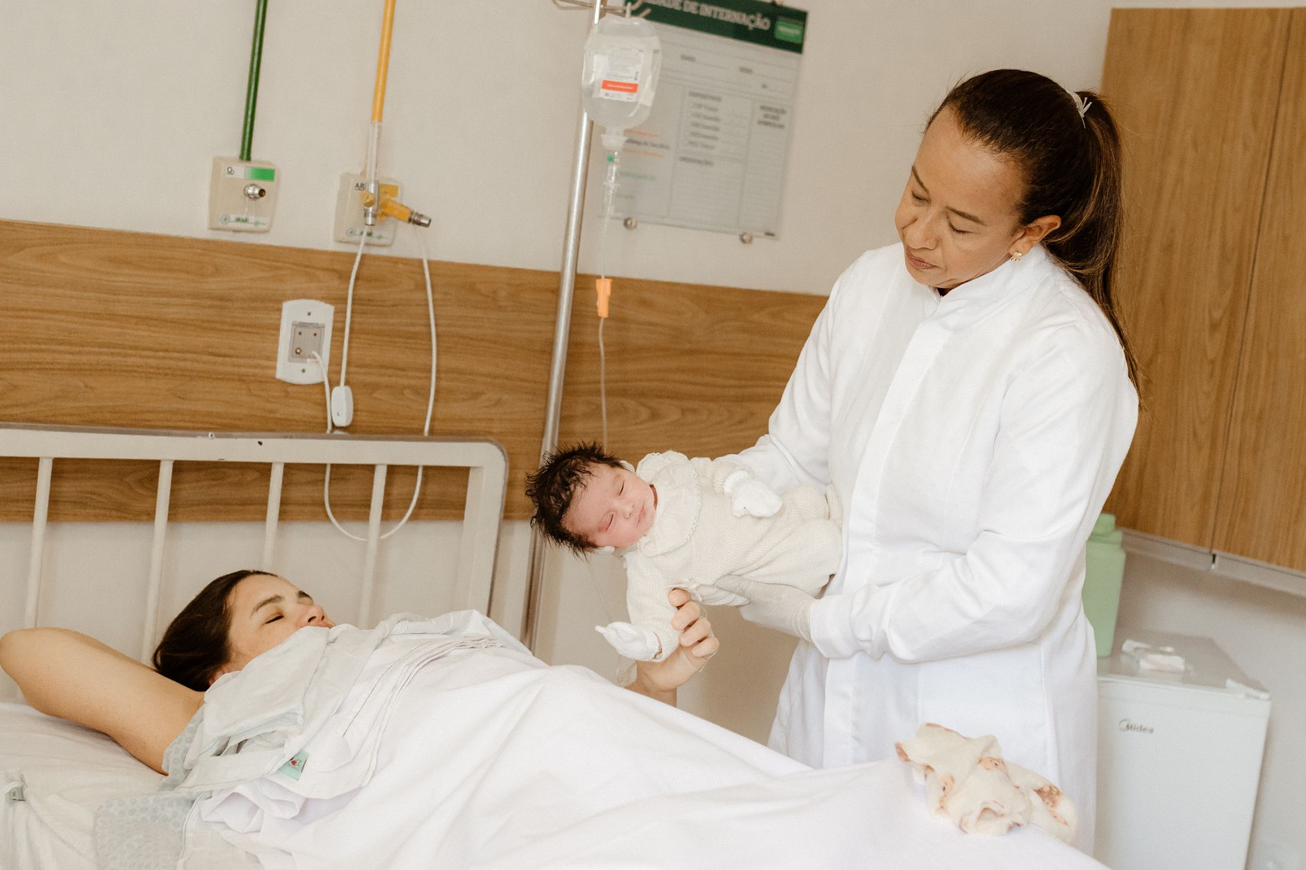 Mother-in-law assisting with diaper change.
