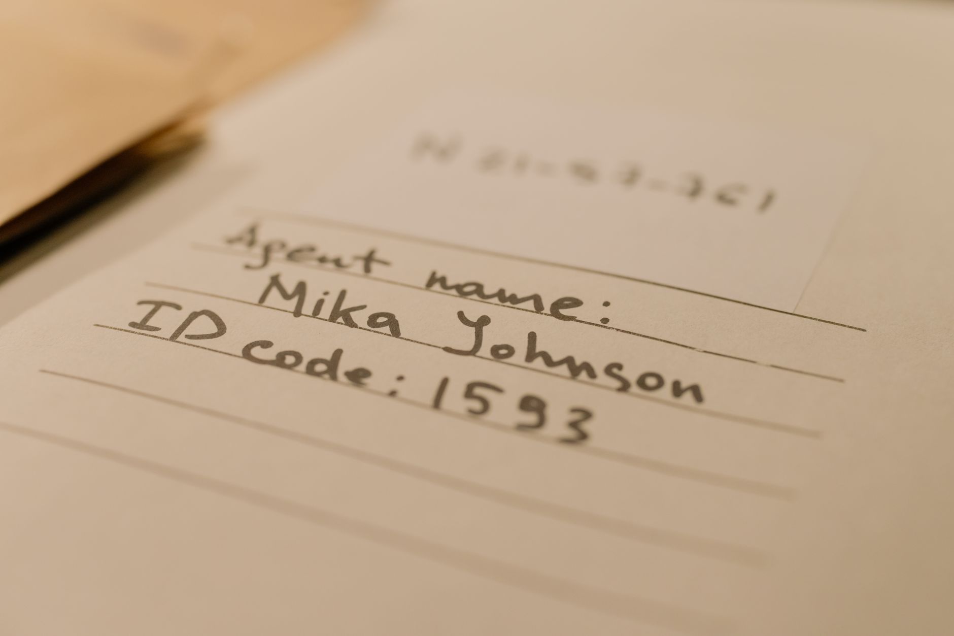 Close‑up of a handwritten baby name list with numbers beside each name, soft pastel background, warm lighting