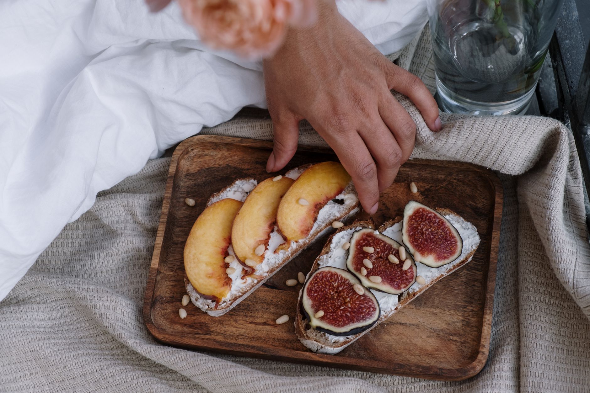 A table laid out with fresh fruits, nuts, and a glass of water, illustrating nutrient‑rich foods for labor preparation