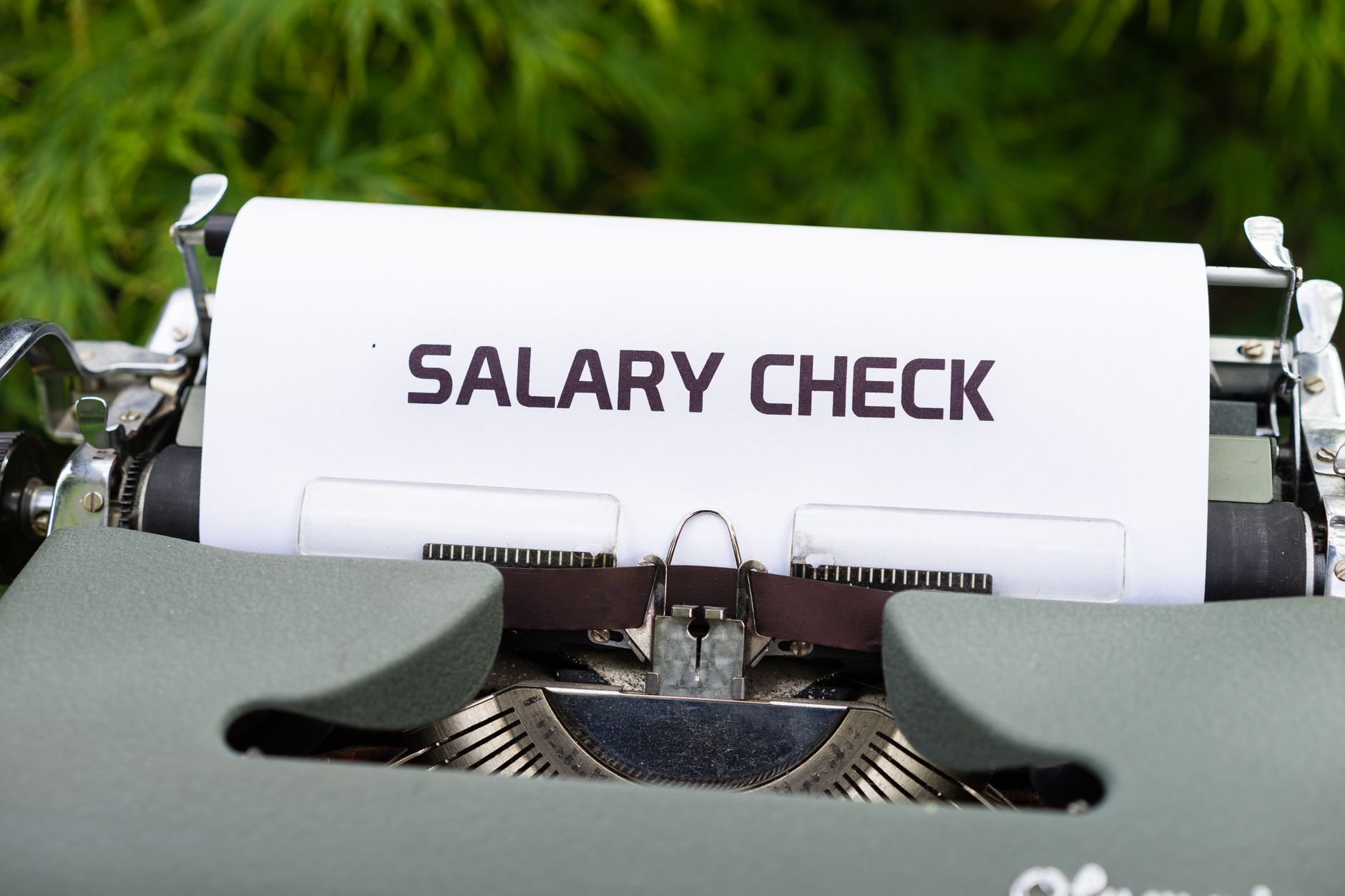 A desk with salary negotiation notes, research, and scripts laid out for a returning mom.