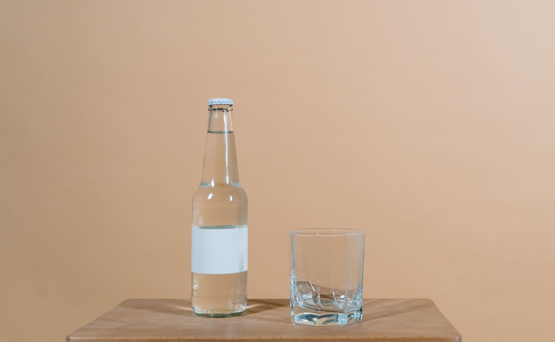 Close‑up of a slow‑flow baby bottle nipple on a wooden surface, soft natural light highlighting the vent design
