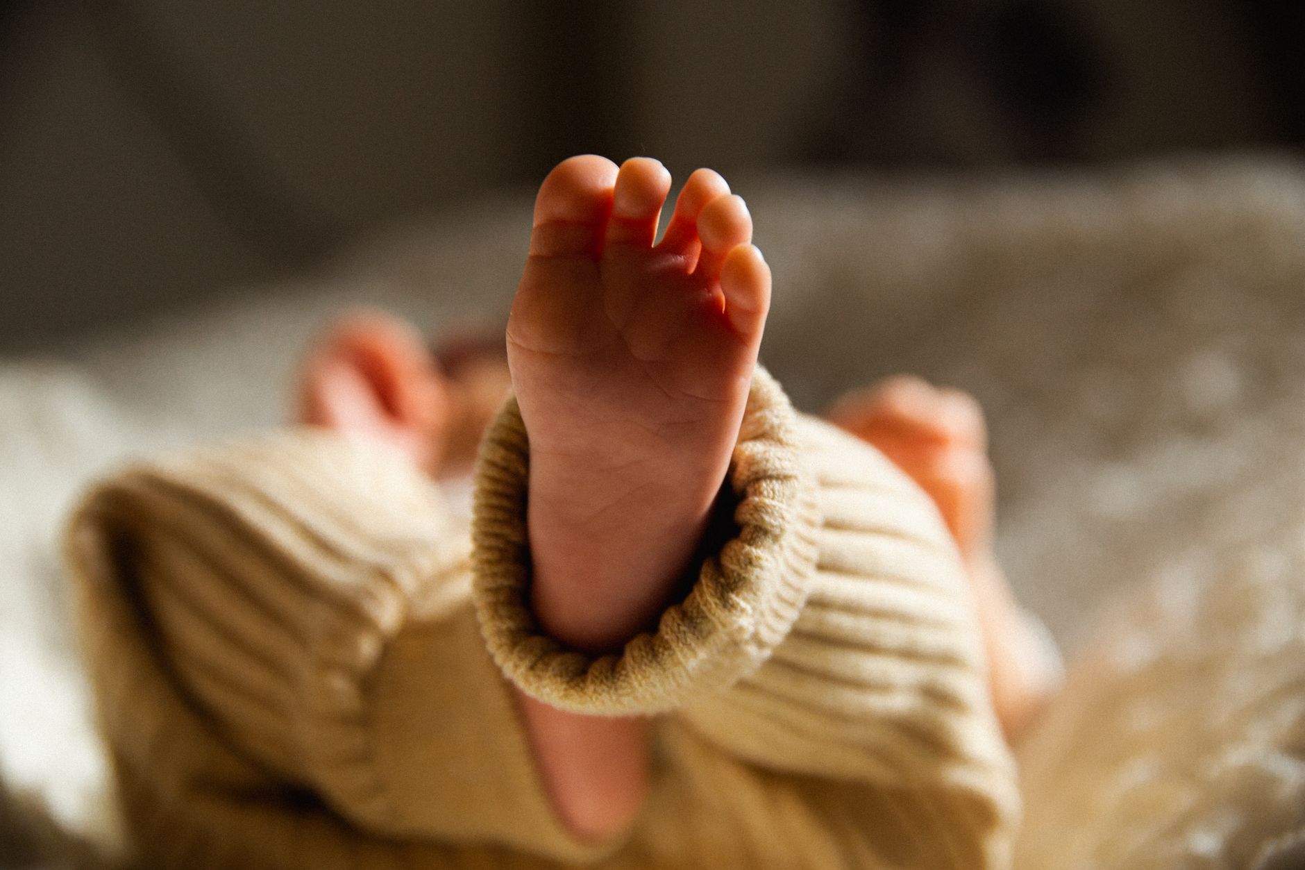 A close‑up of a newborn’s chest with a soft focus, showing gentle breathing movements during a hiccup episode