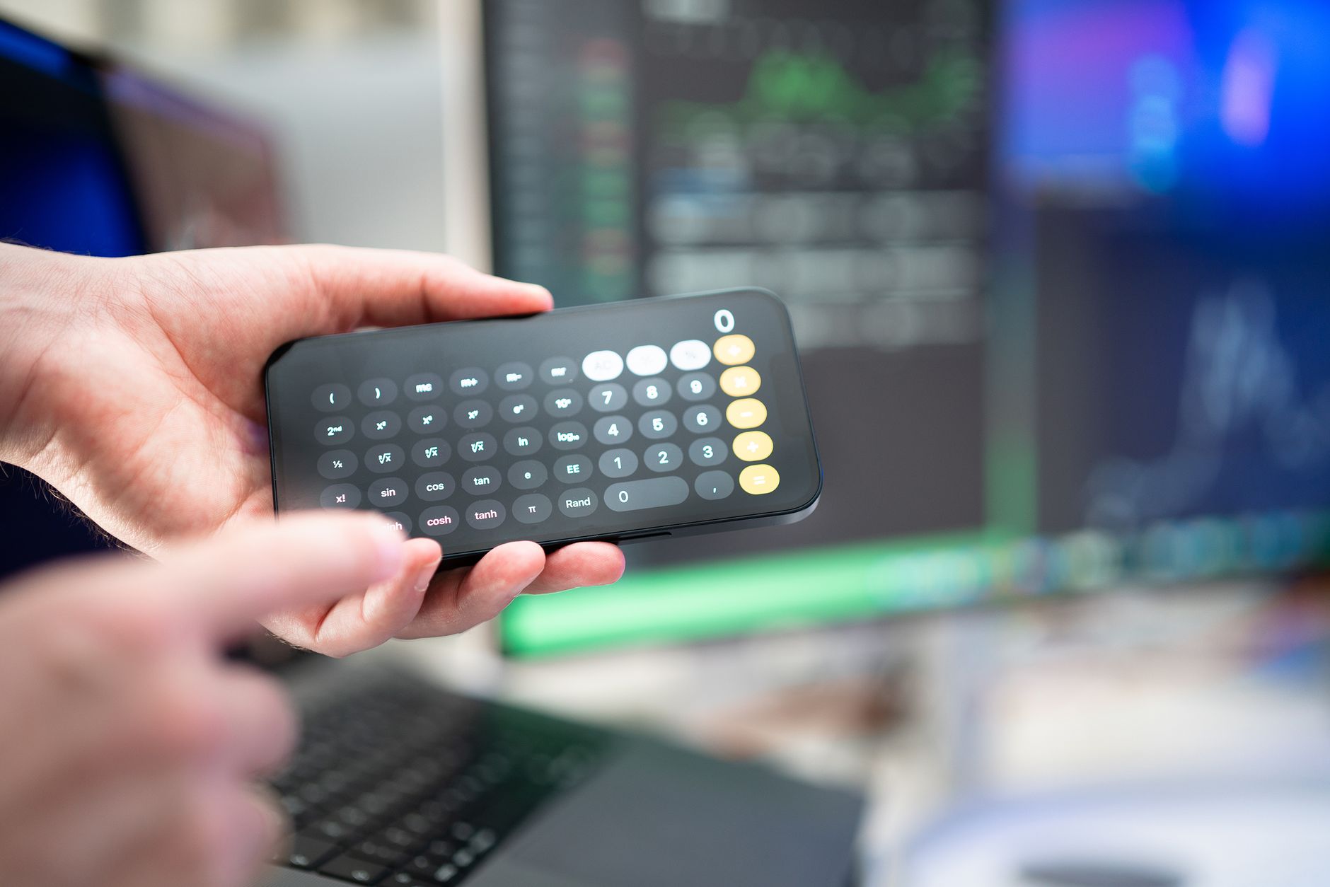 A parent holding a smartphone with a CRIB-II calculator on the screen, showing a score of 10