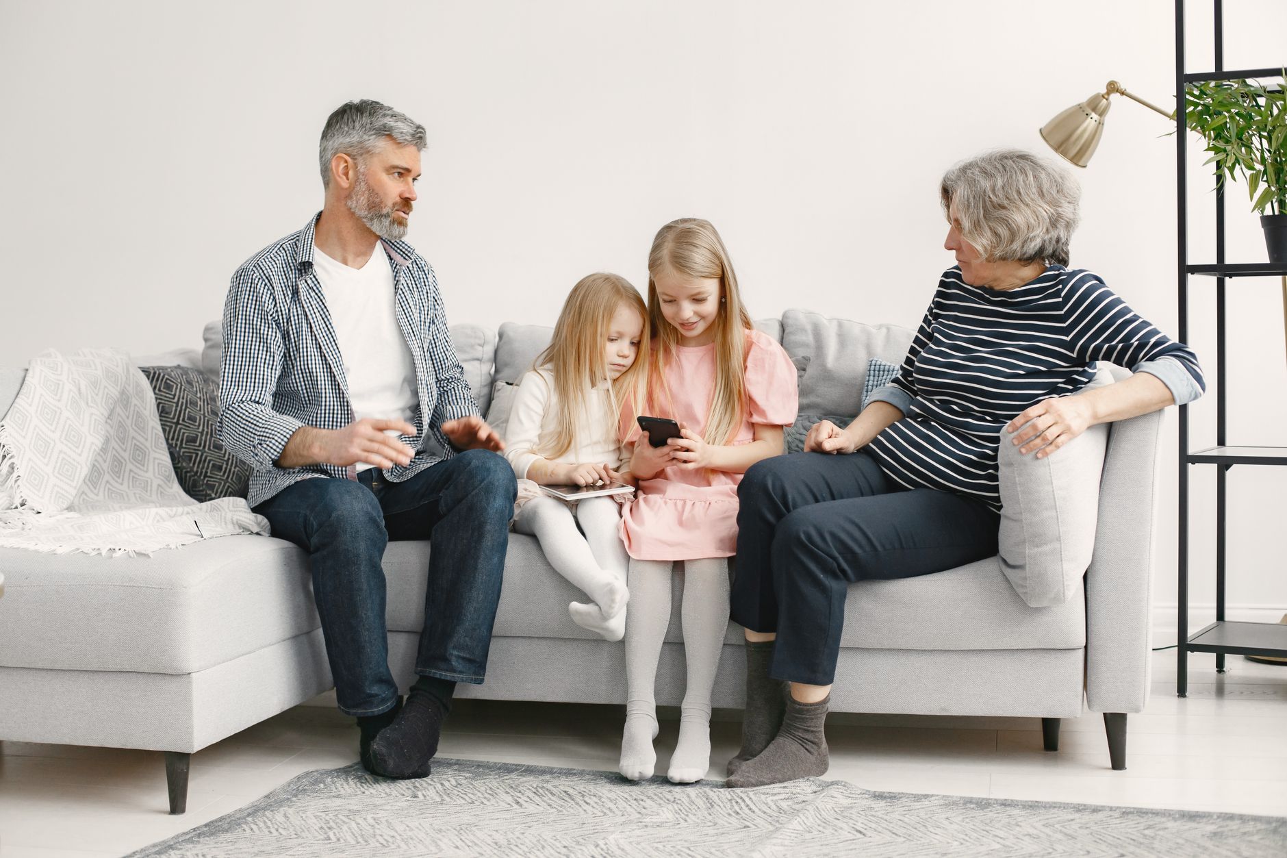 Pregnant woman with grandparents in a cozy living room