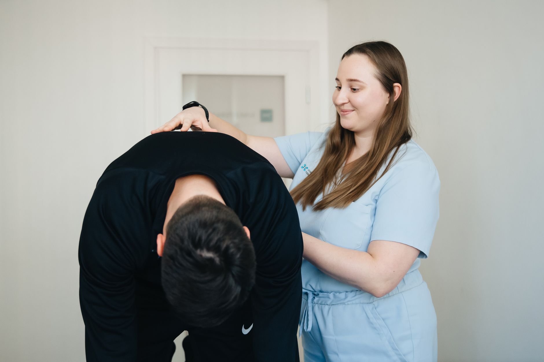 Pelvic floor therapist assisting new mom