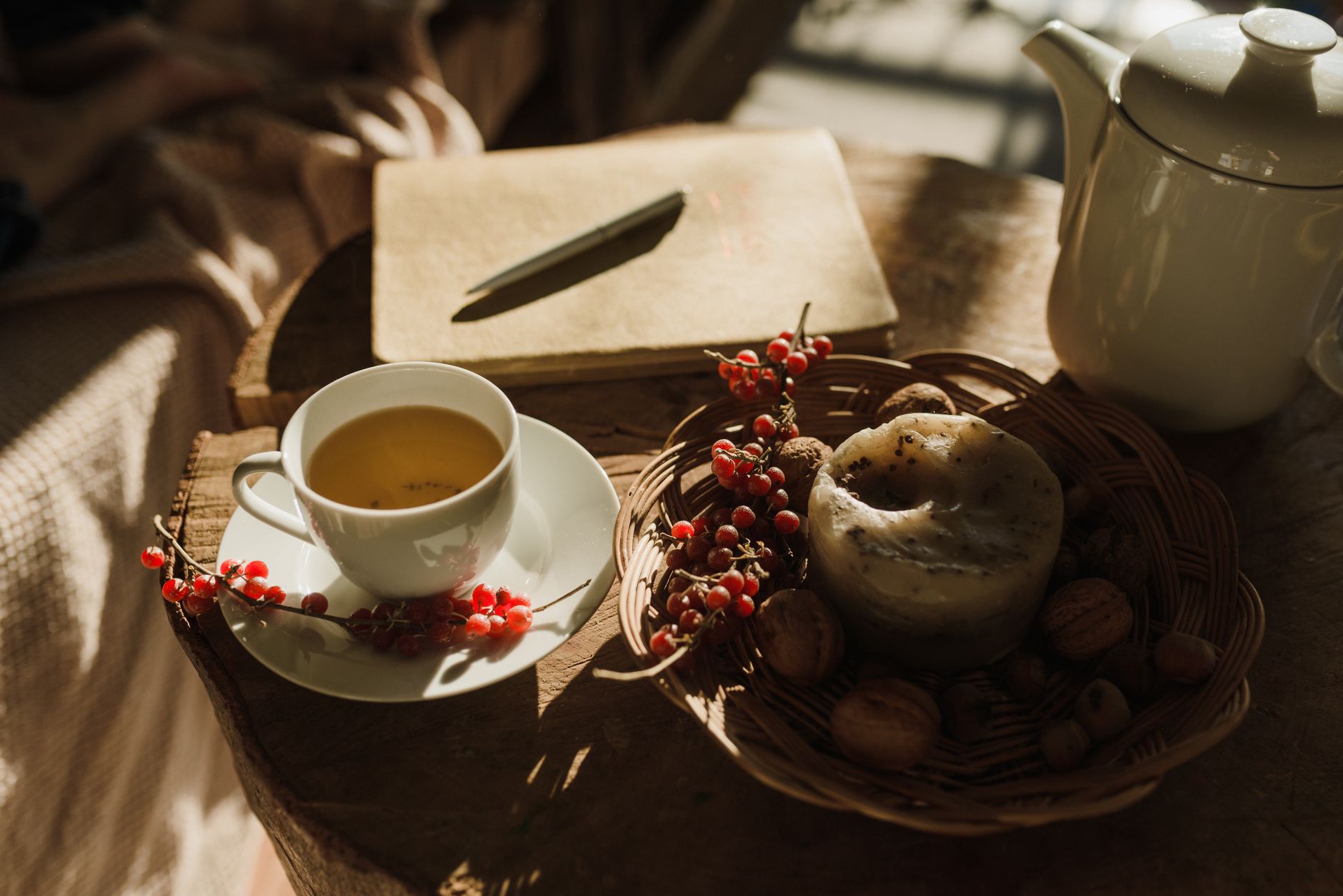 A calm sitting area with a journal, a cup of tea, and soft candlelight, creating a soothing environment for reflection and mindfulness