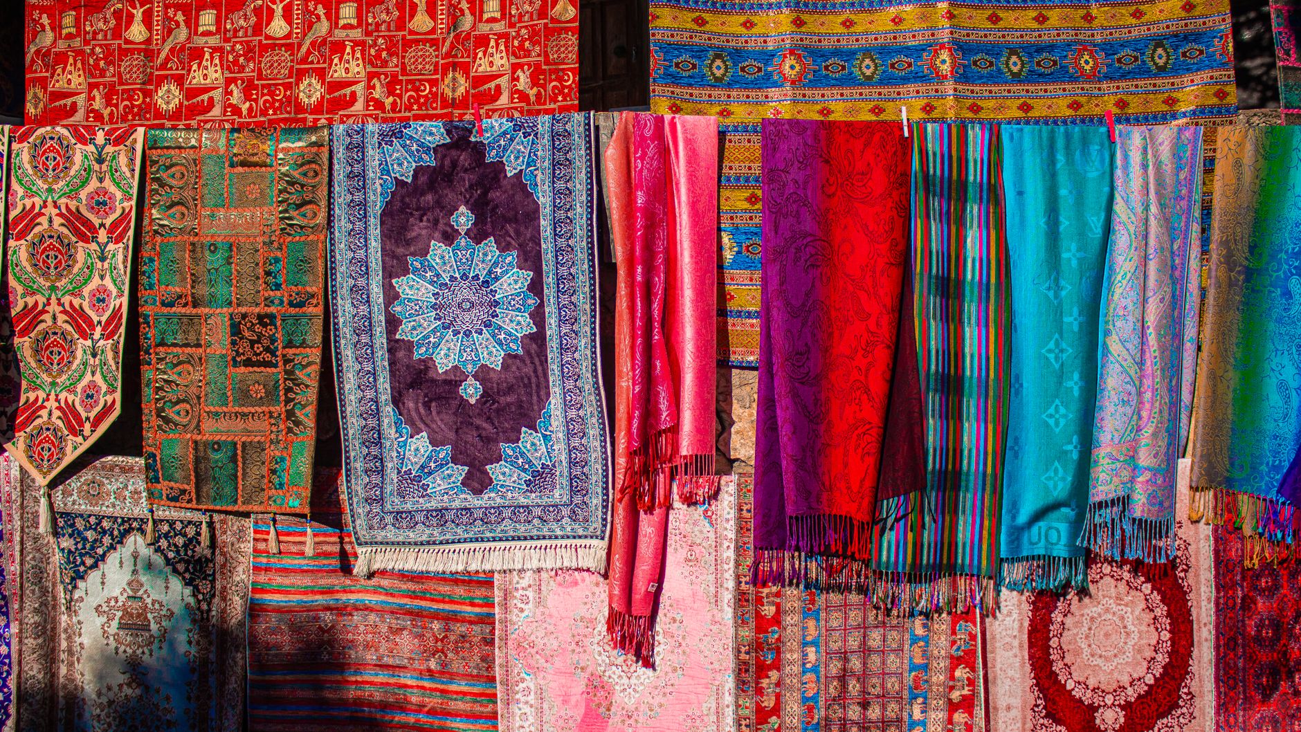 A vibrant tapestry of symbols from different cultures, including a stylized pregnant figure, woven into a textile background, celebrating diversity in dream interpretation
