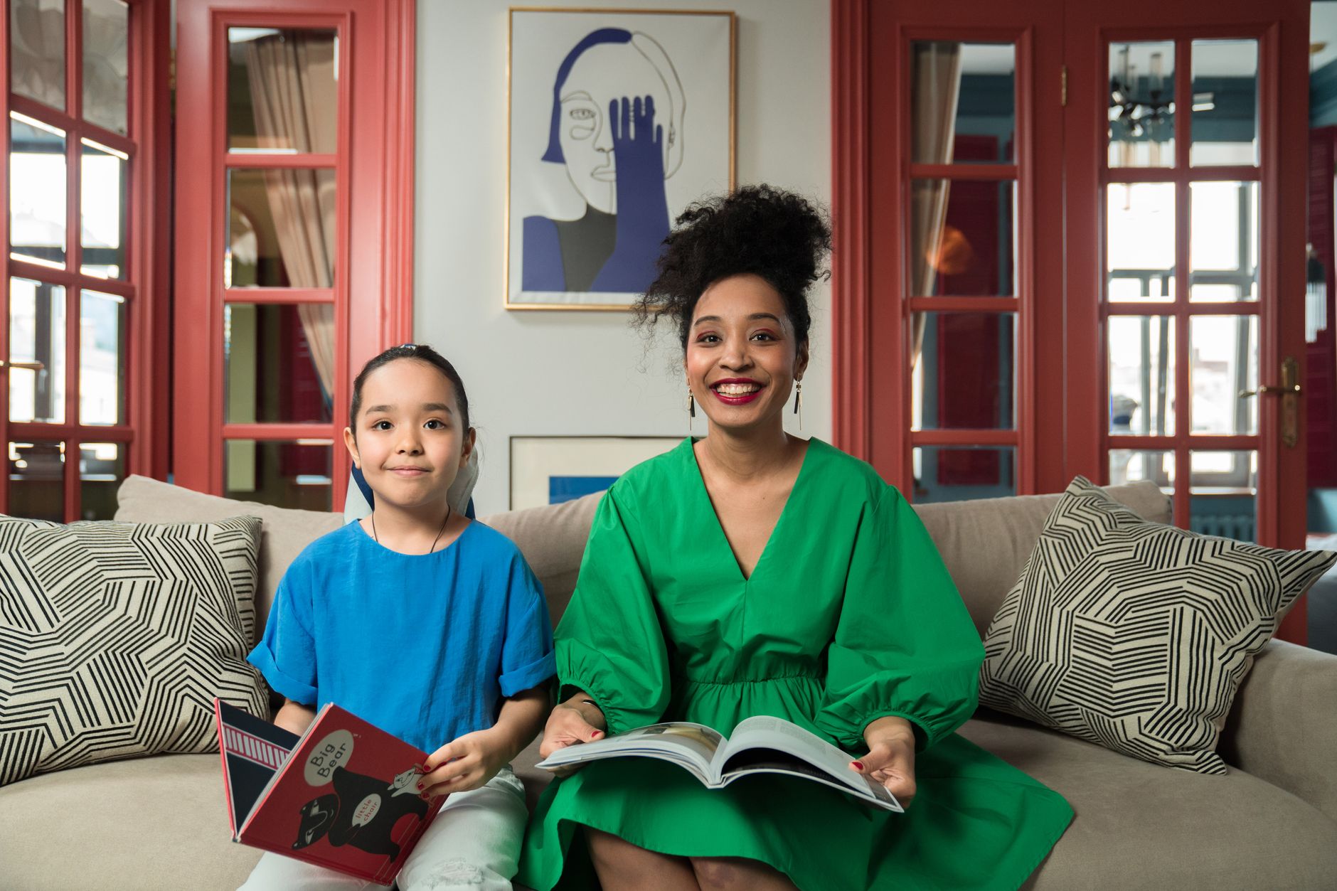 Mother reading a baby book to older child