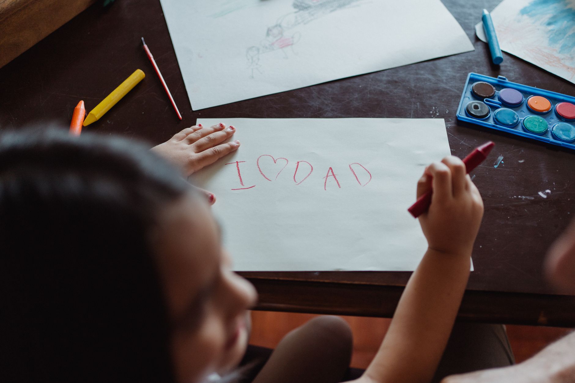 Child making DIY sibling preparation book