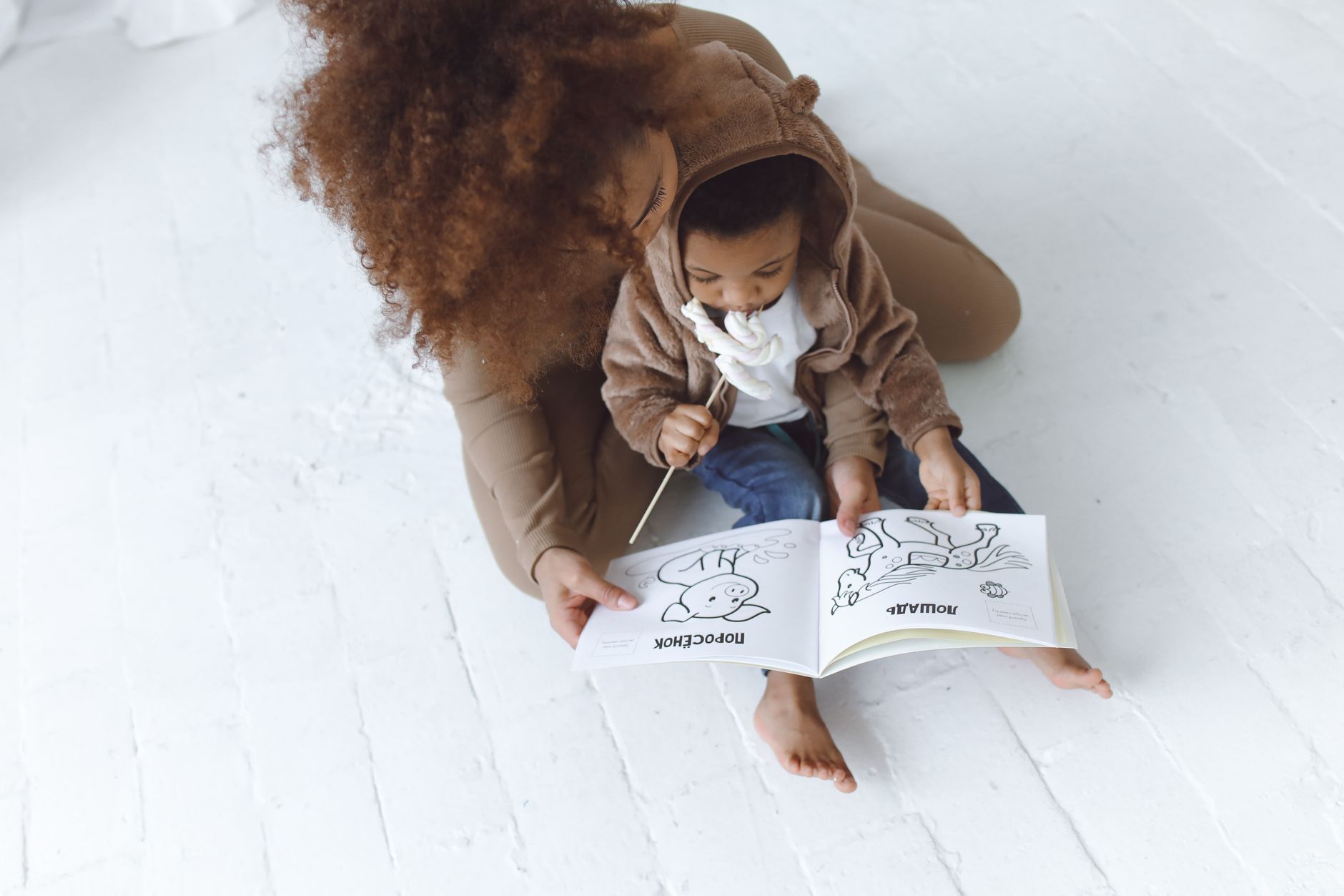 Pregnant mom coloring with toddler about the new baby