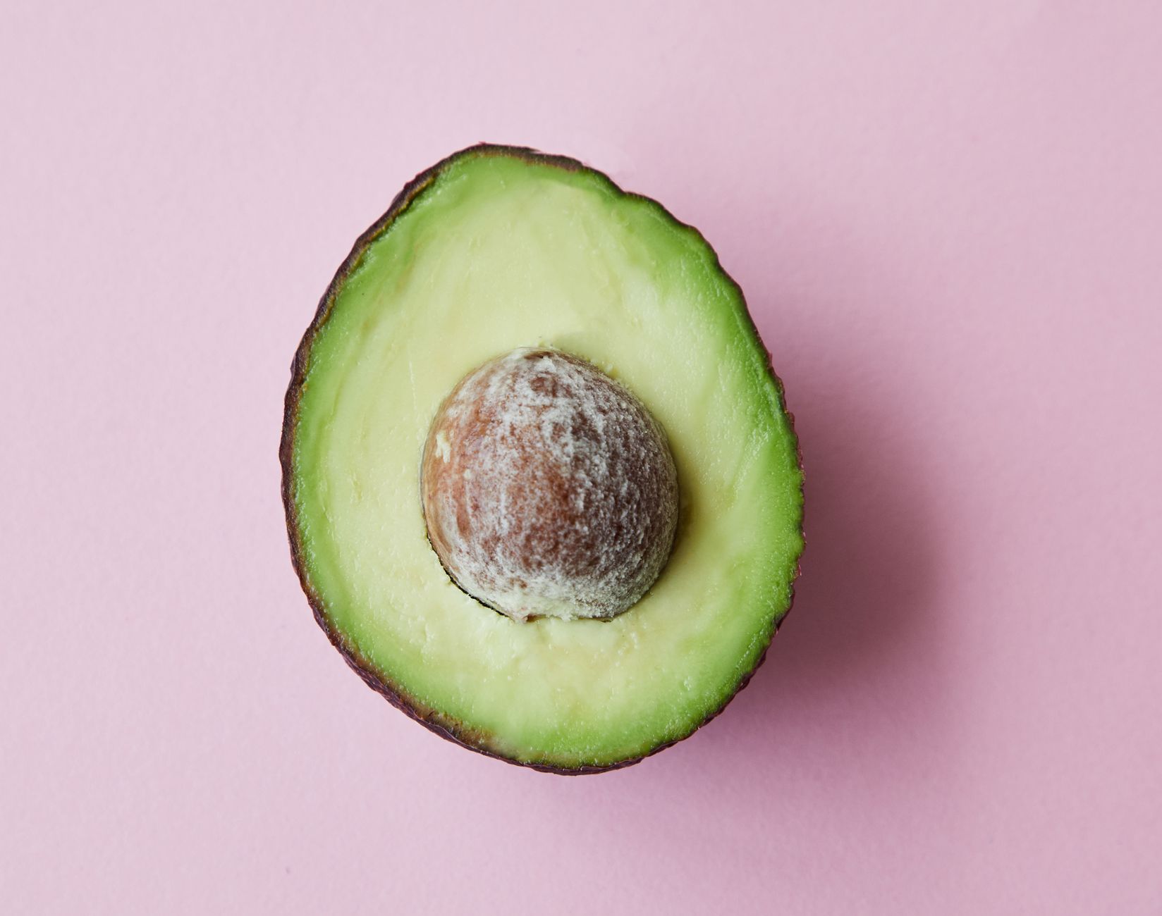 Freshly sliced avocado, a hard‑boiled egg, a handful of almonds, and a cup of fortified soy milk arranged on a pastel ceramic plate, illustrating a balanced protein snack for pregnant women