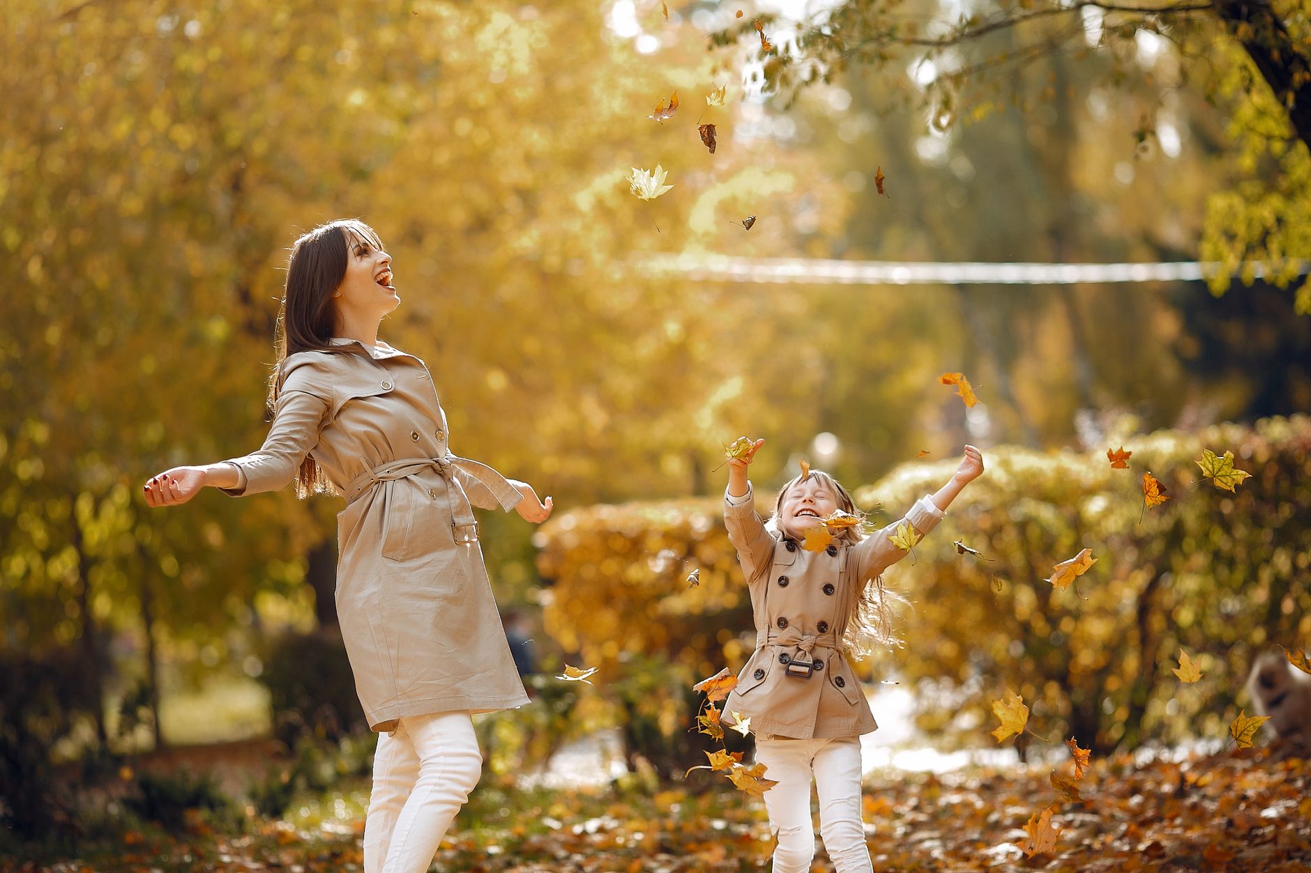 A joyful mom and child playing together in a sunny park, a clear example of work-life balance.