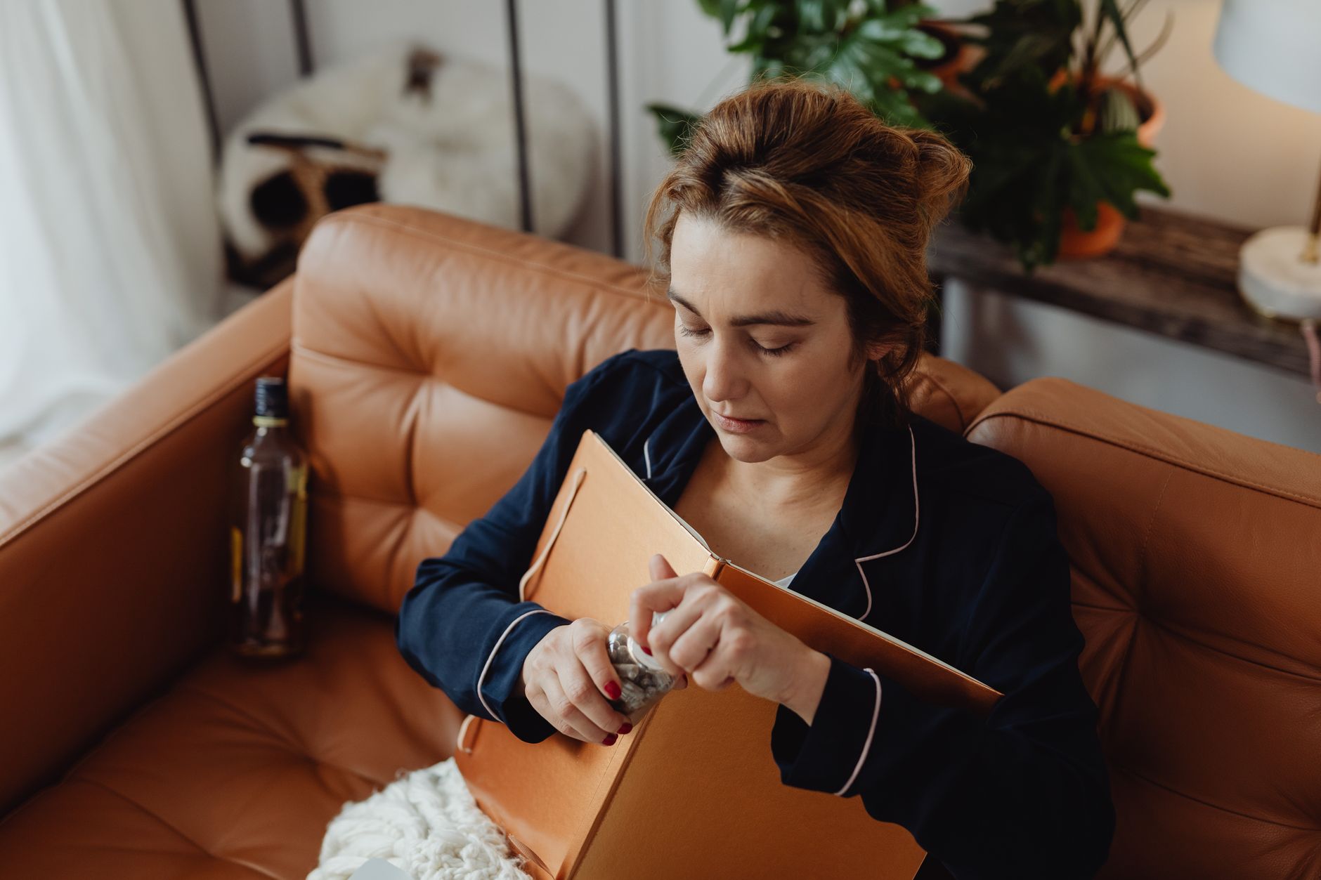 Woman journaling in a peaceful home setting.