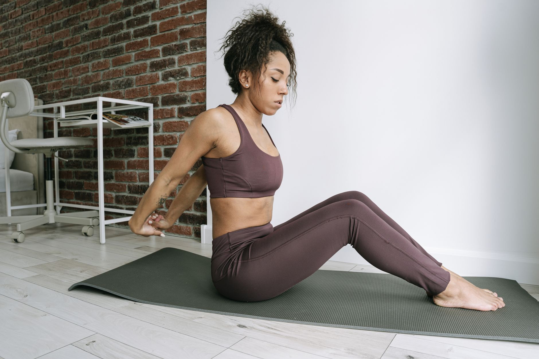 Woman demonstrating a seated core exercise