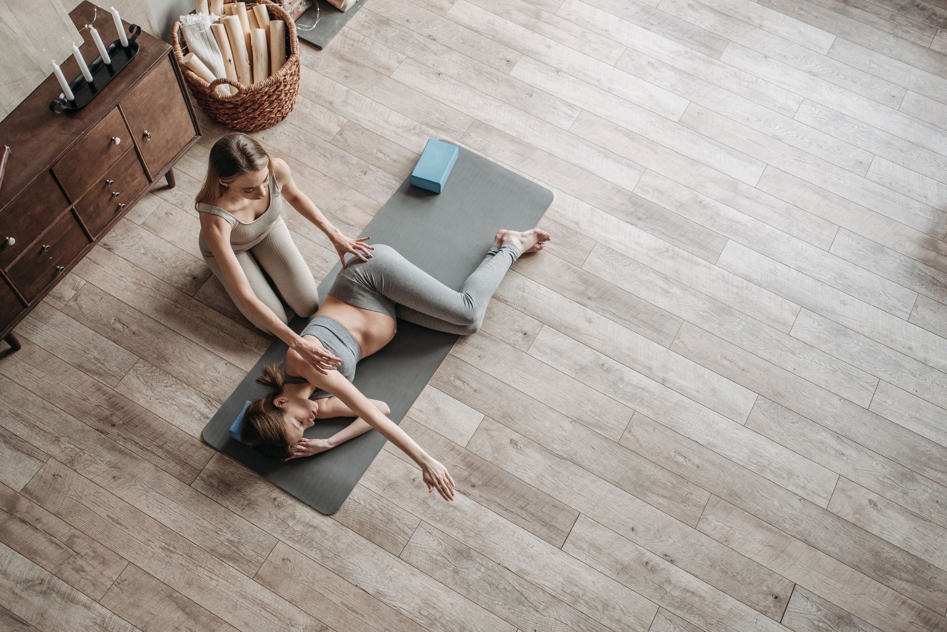 Postpartum mother doing yoga while baby sleeps