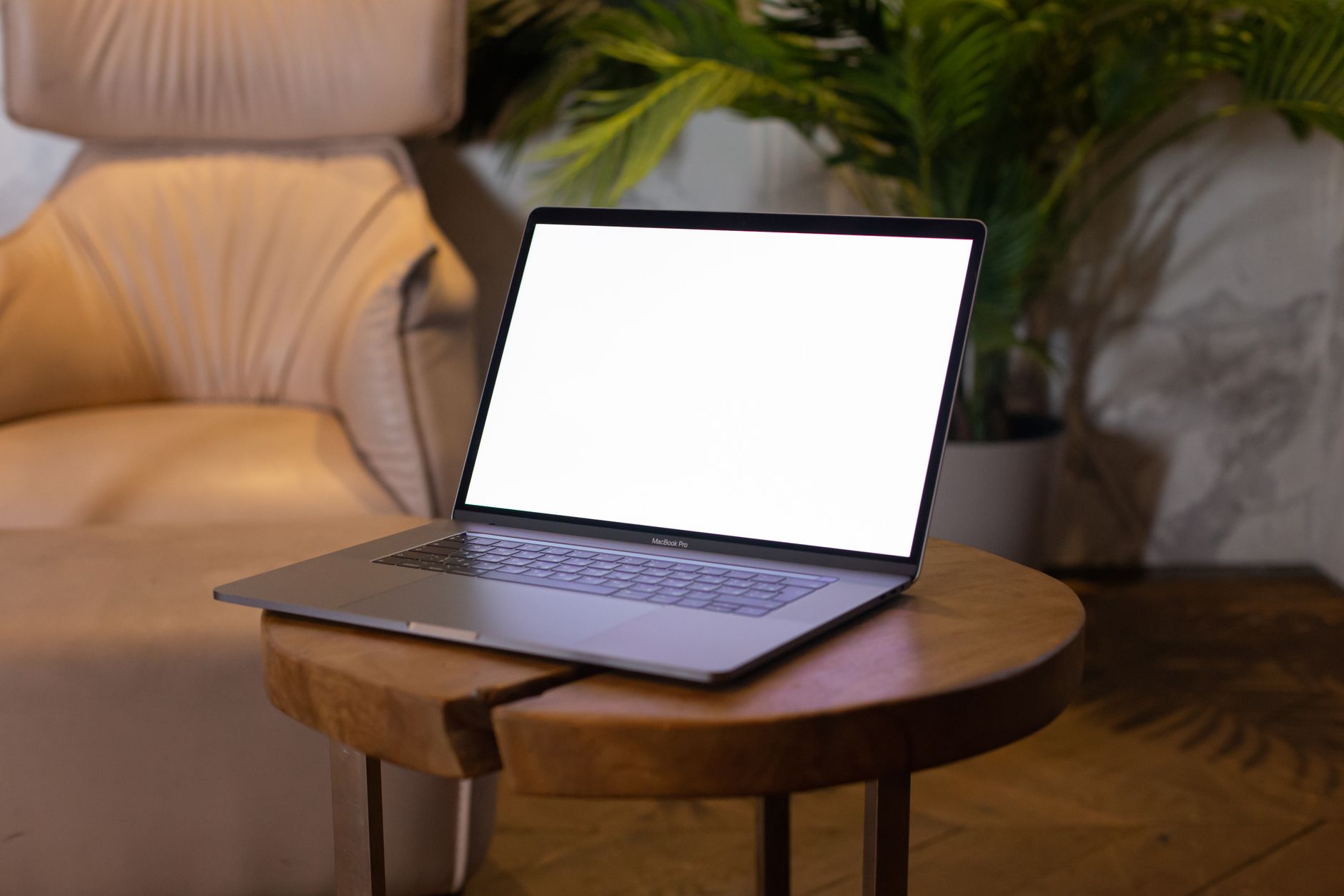 Close‑up of a mother holding a printable safe‑sleep checklist, with a laptop showing the calculator results beside a newborn sleeping peacefully