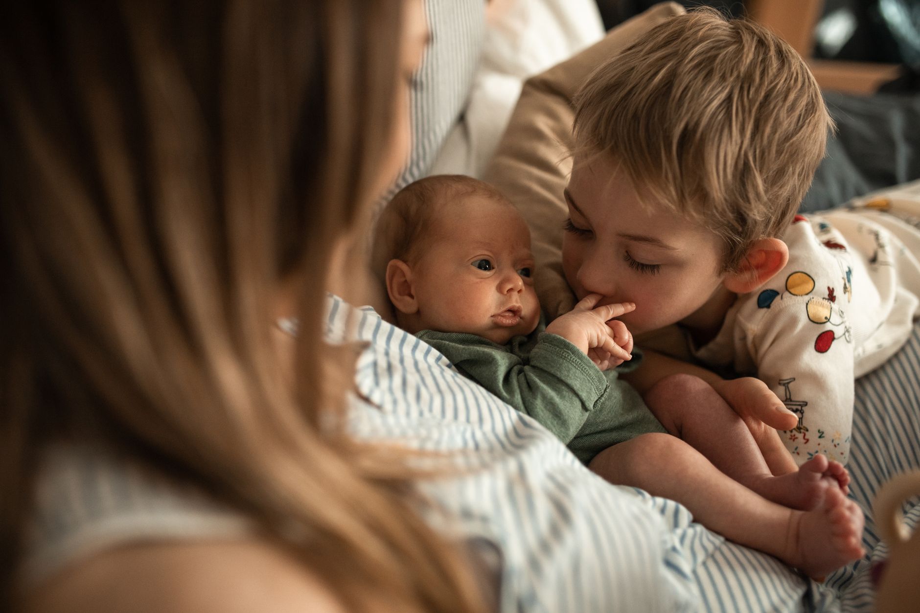 Older sibling with newborn at baby shower