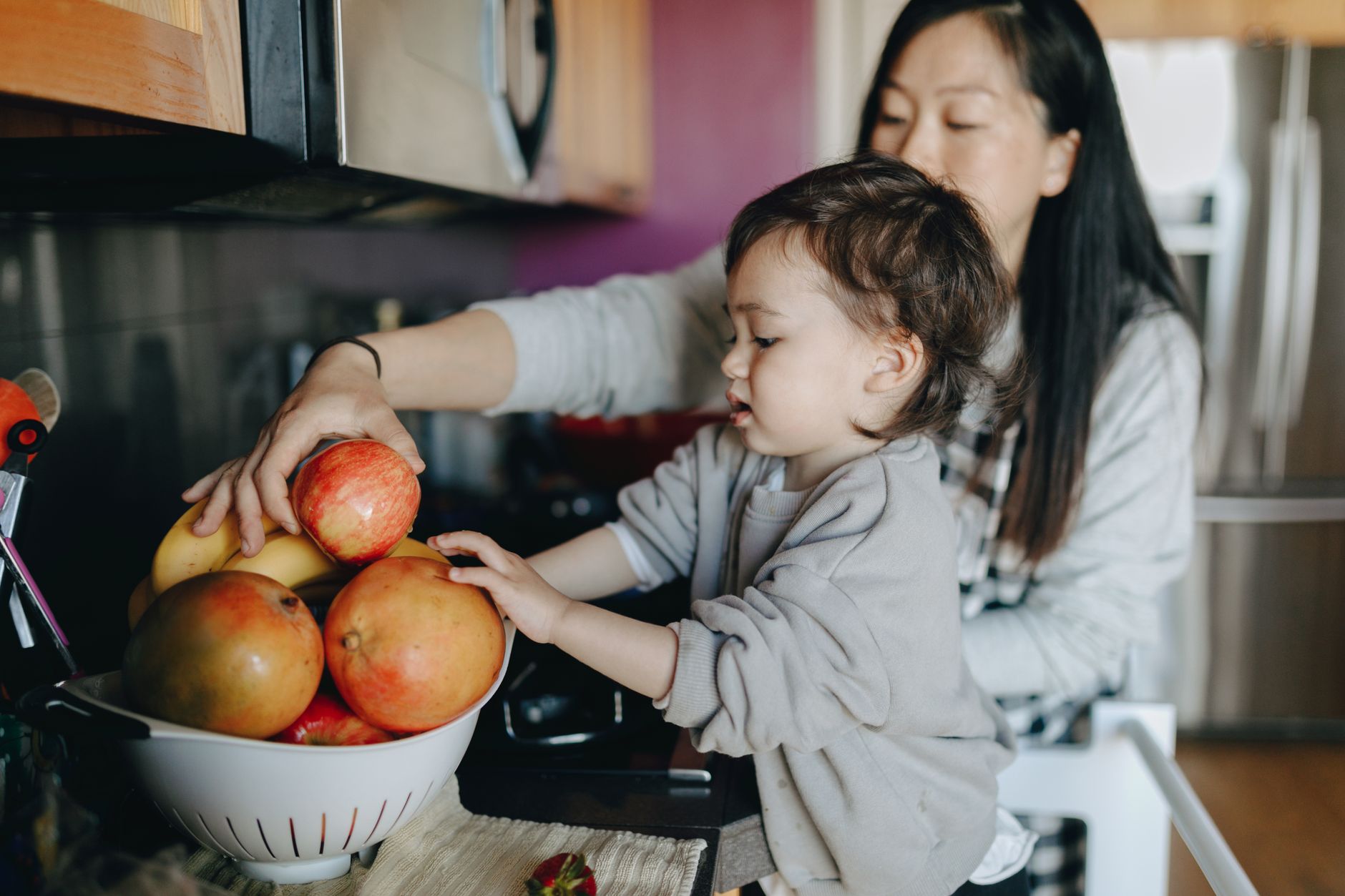 Mother preparing healthy snack in kitchen
