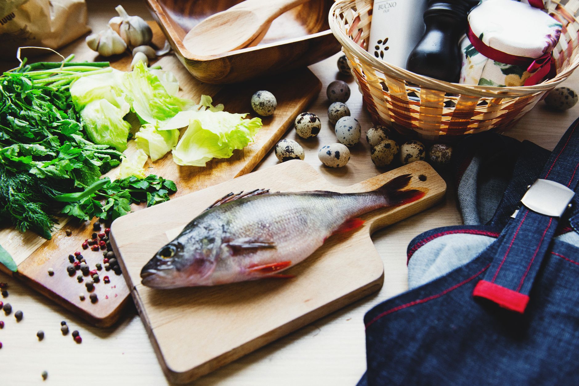 Colorful assortment of pregnancy‑friendly foods: leafy greens, berries, salmon, and fortified yogurt on a wooden board