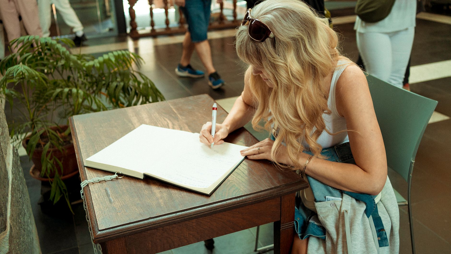 A woman writing in a journal.