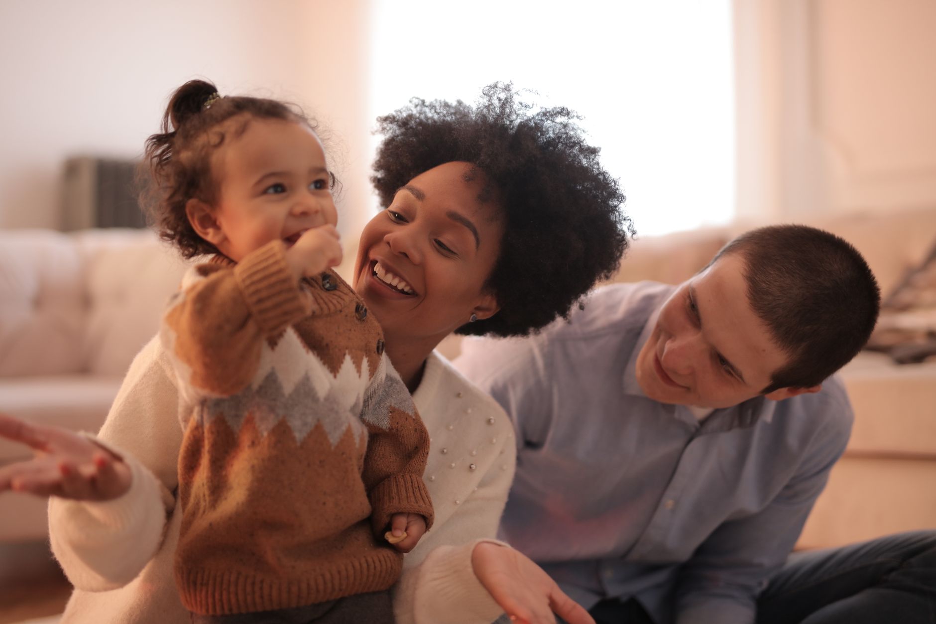 Parents and toddlers laughing at a park meetup