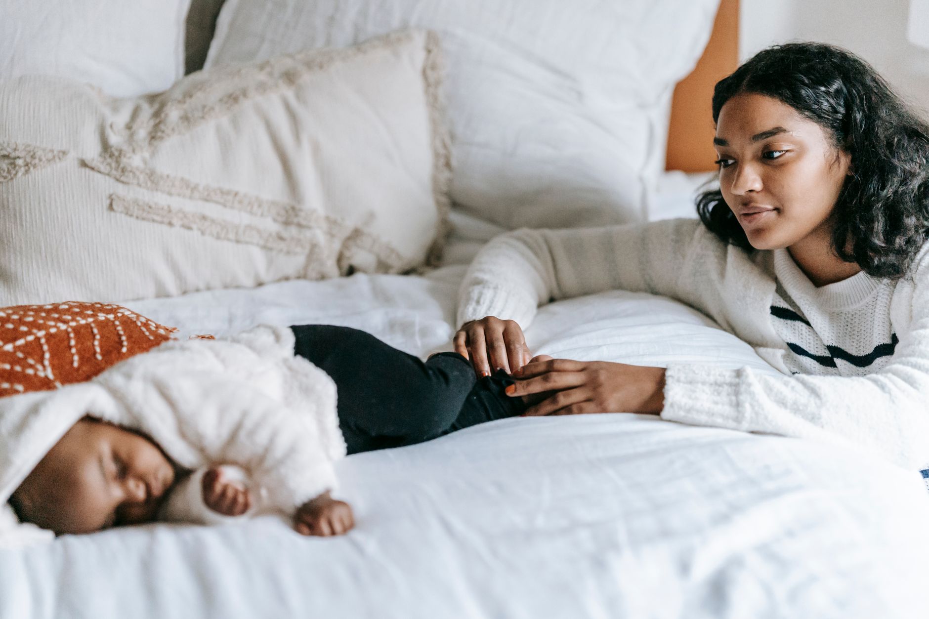 A cozy bedroom setup with blackout curtains, a weighted blanket, and a nightlight for a newborn