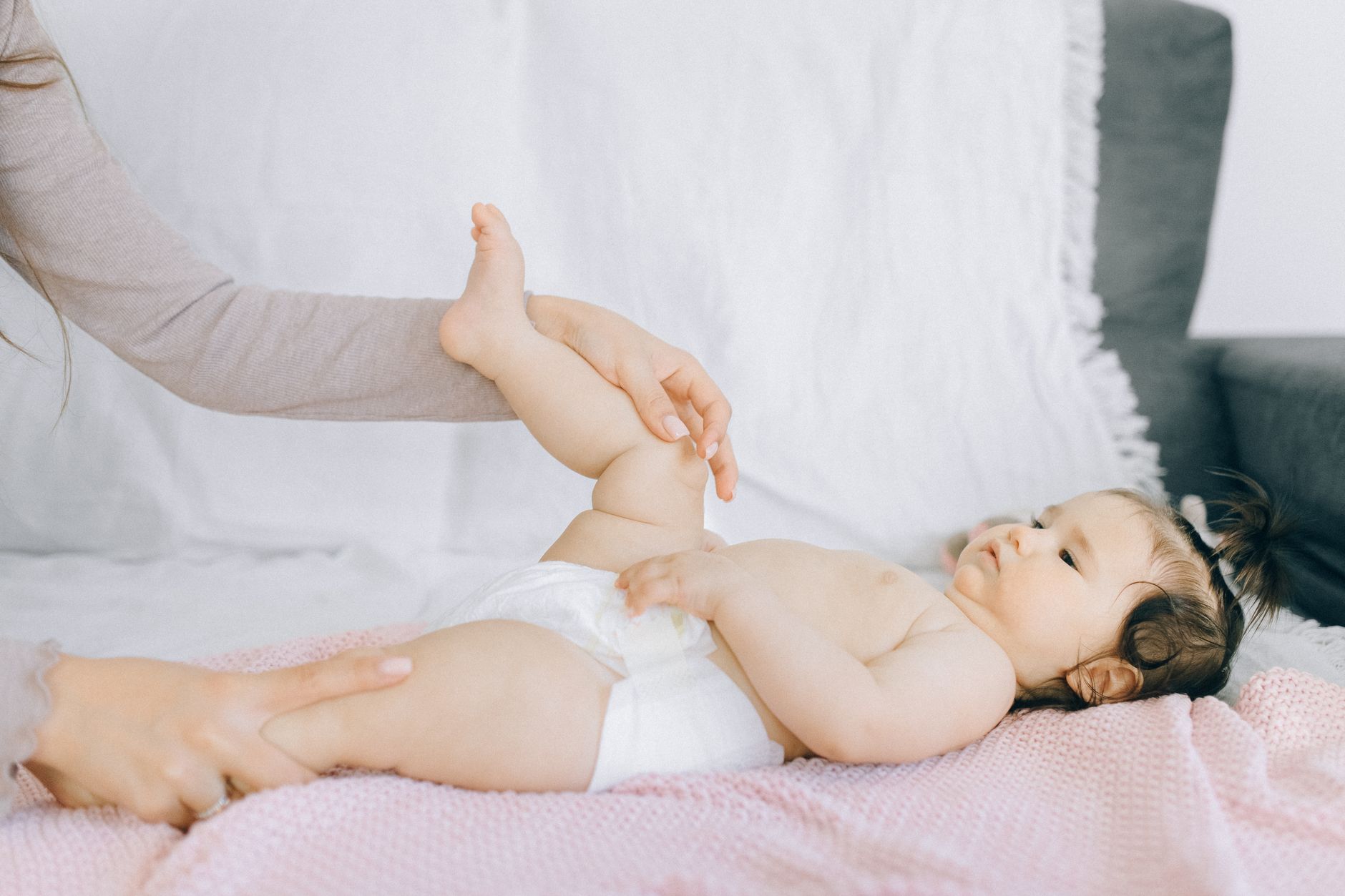 Parent massaging baby gums