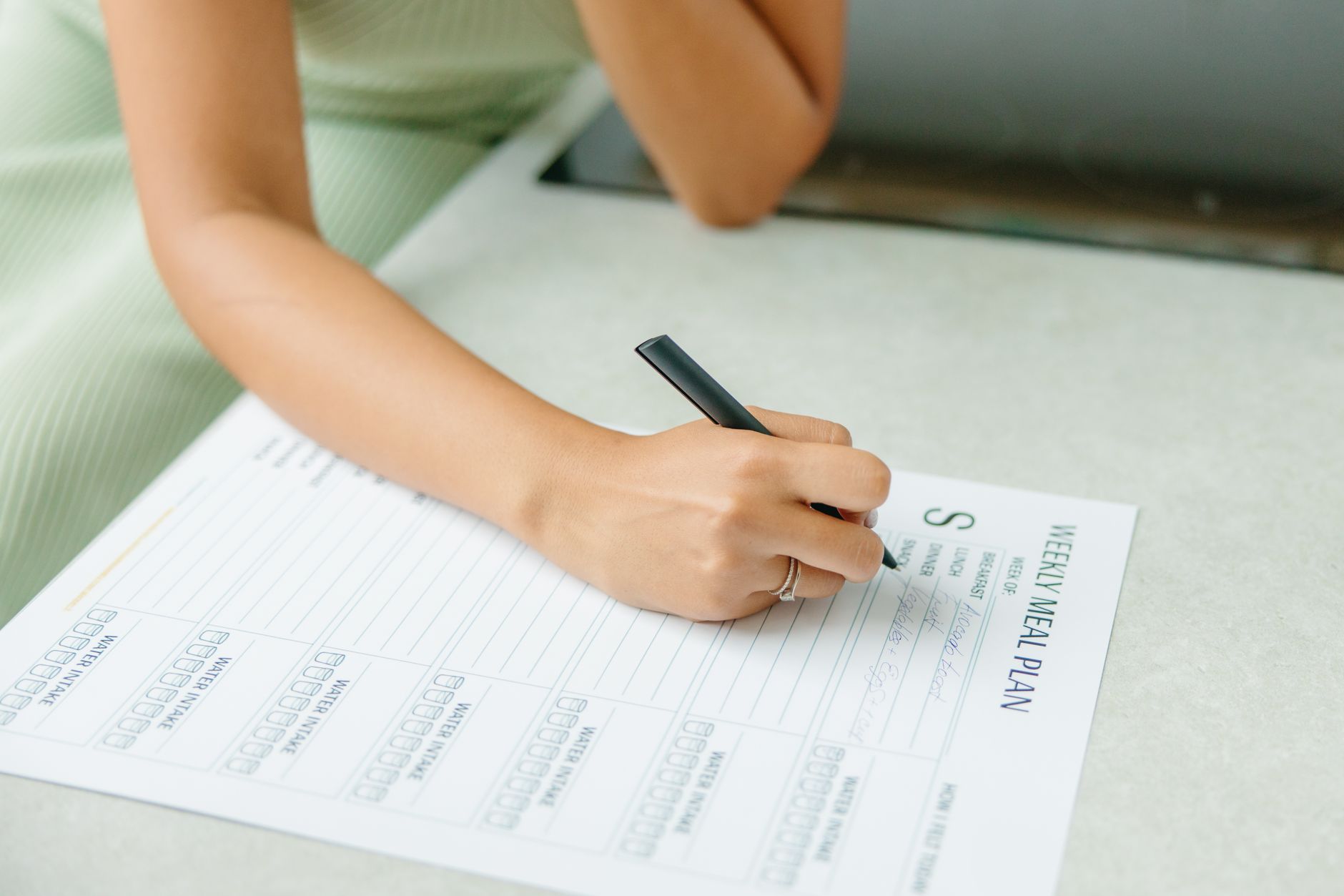 Mom organizing a freezer meal plan with a checklist