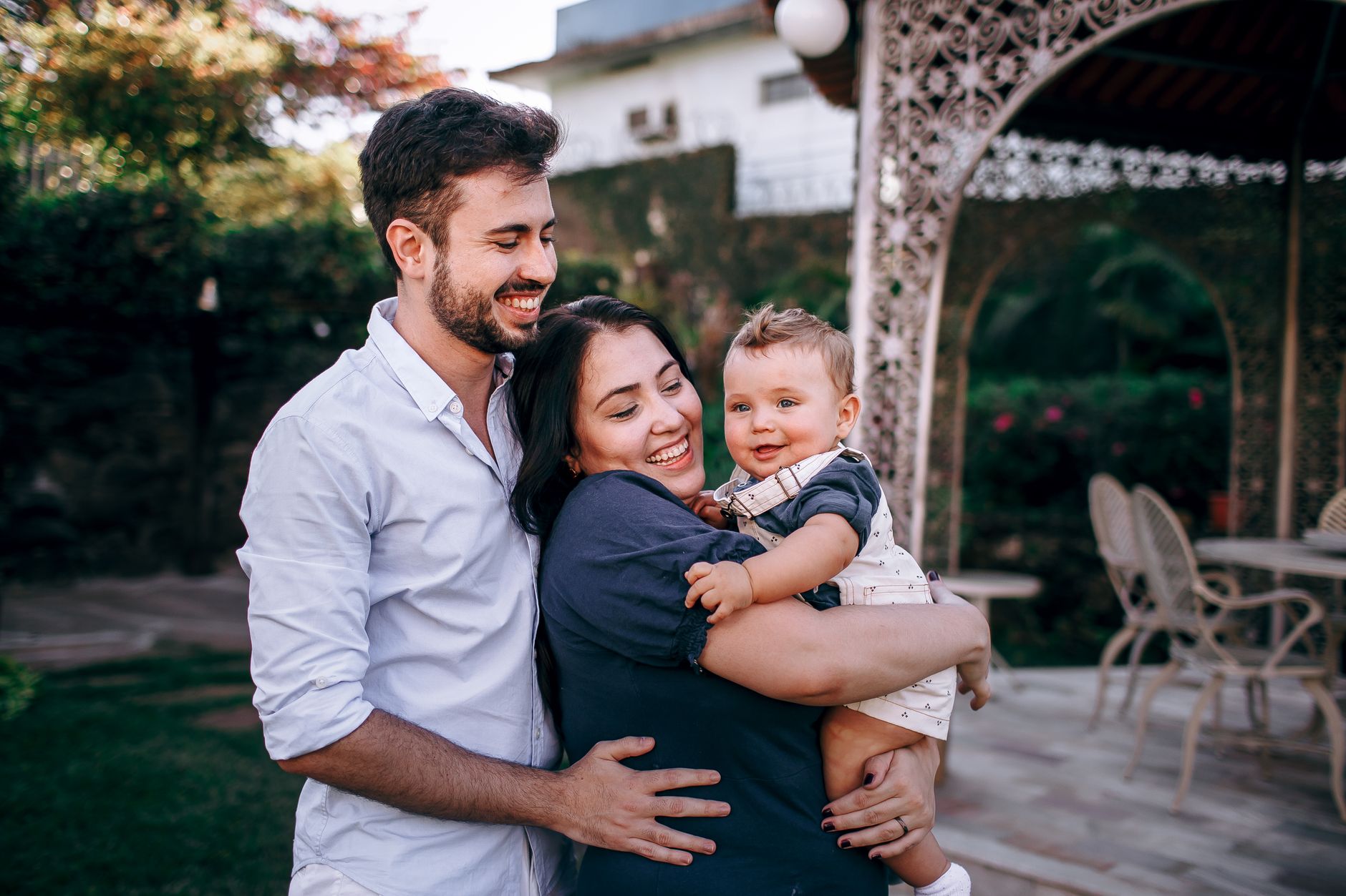 A parent looking relieved and happy, holding a content baby, symbolizing the positive outcome of successful sleep training.