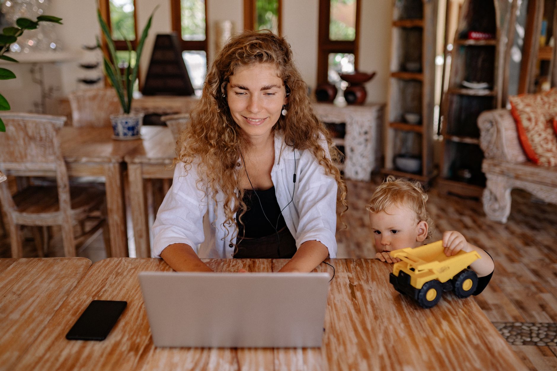 Mother using a breast pump in a private workplace lactation room
