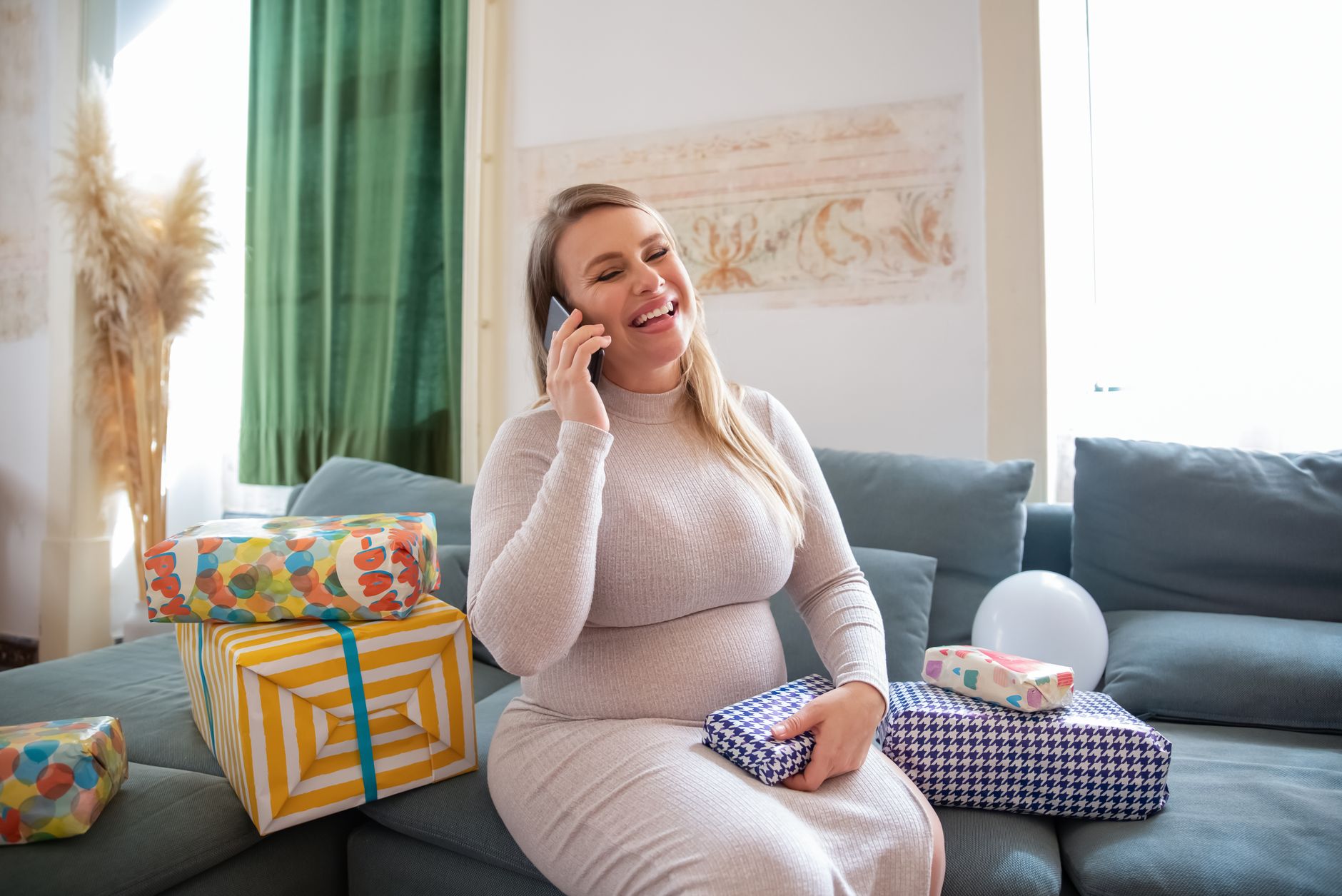 Pregnant woman on the phone with her doctor, looking concerned but relieved