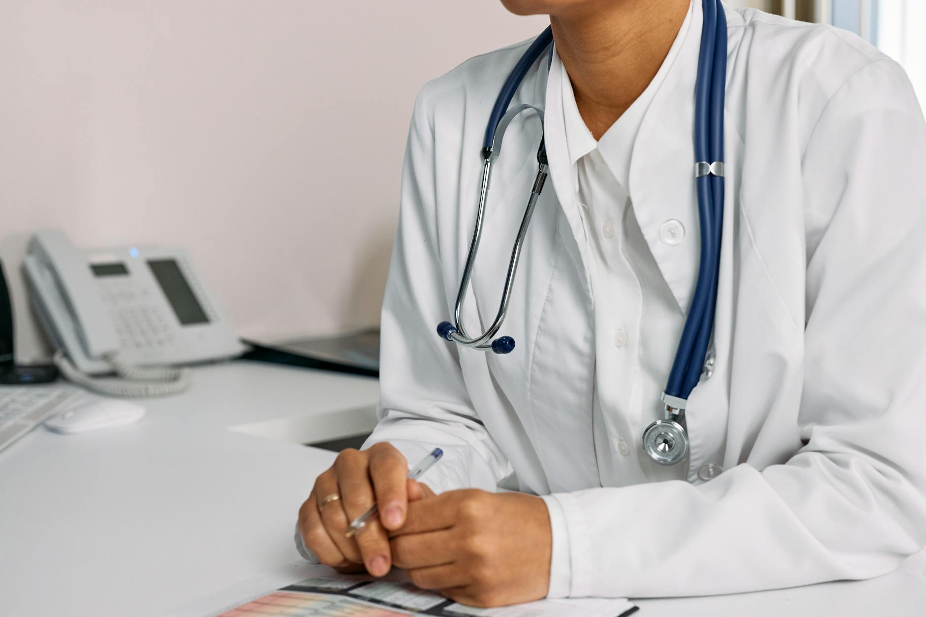 A doctor talking to a pregnant woman, with a concerned expression