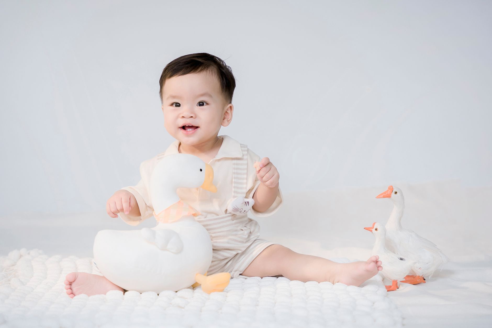Pull‑up toy on a soft rug encouraging baby to pull to stand