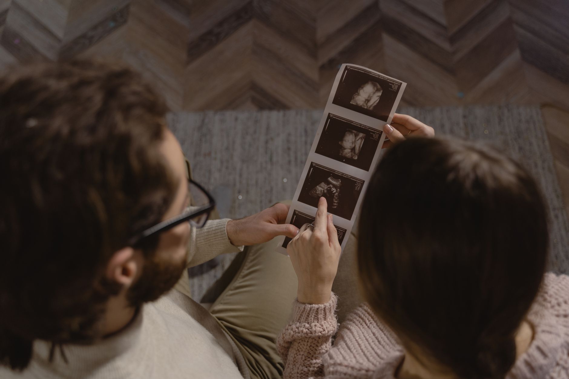 Parent reading picture books to baby