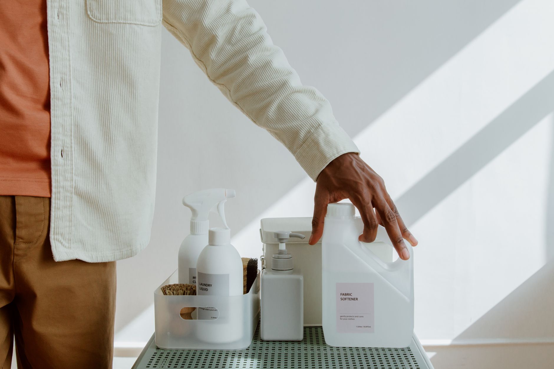 Hypoallergenic detergent next to baby clothes