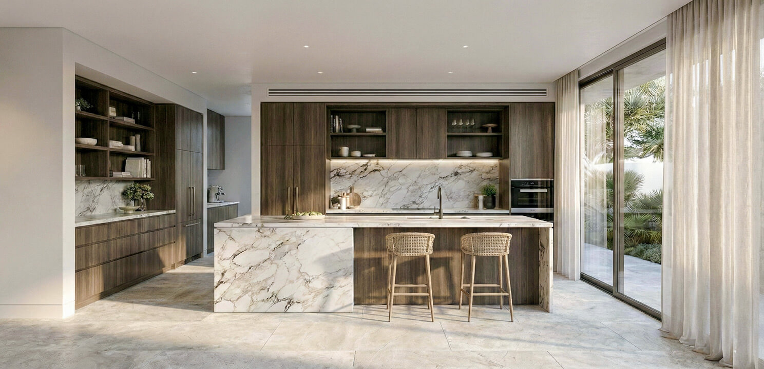 Modern kitchen with dark walnut timber cabinetry and a white marble backsplash. A large marble island bench stands in the center with two woven bar stools. Sliding glass doors on the right bring in natural light.
